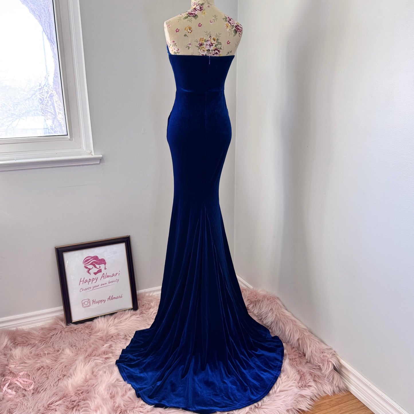 Step into timeless elegance with this breathtaking previously cherished royal blue velvet evening gown, designed to turn heads at any event. Crafted from rich, ultra-soft velvet, this figure-hugging masterpiece features a structured corset bodice with delicate pleated detailing that accentuates your silhouette. The sweetheart neckline adds a touch of romance, while the flowing skirt with a sultry thigh-high slit creates the perfect balance of sophistication and allure. In perfect condition.