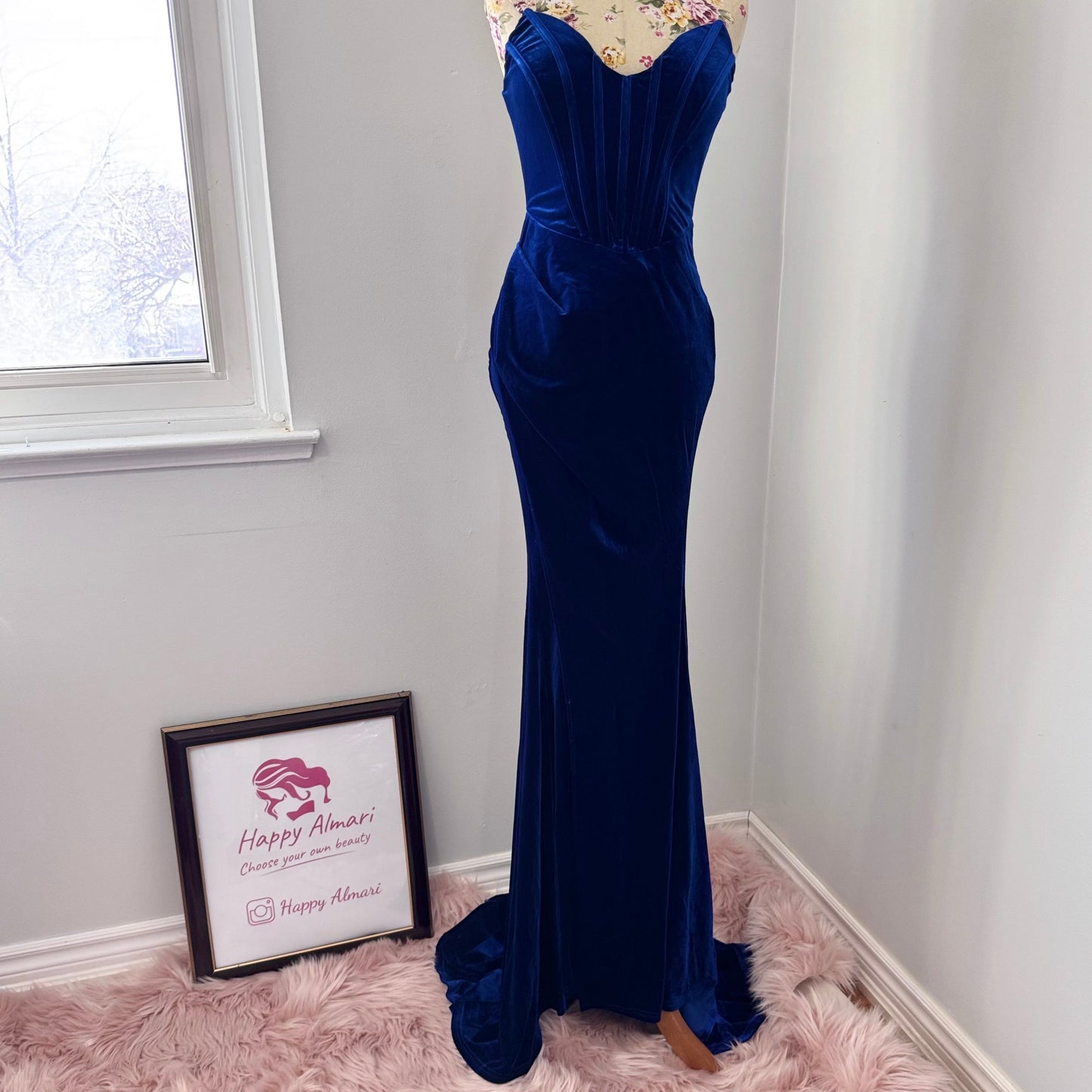 Step into timeless elegance with this breathtaking previously cherished royal blue velvet evening gown, designed to turn heads at any event. Crafted from rich, ultra-soft velvet, this figure-hugging masterpiece features a structured corset bodice with delicate pleated detailing that accentuates your silhouette. The sweetheart neckline adds a touch of romance, while the flowing skirt with a sultry thigh-high slit creates the perfect balance of sophistication and allure. In perfect condition.