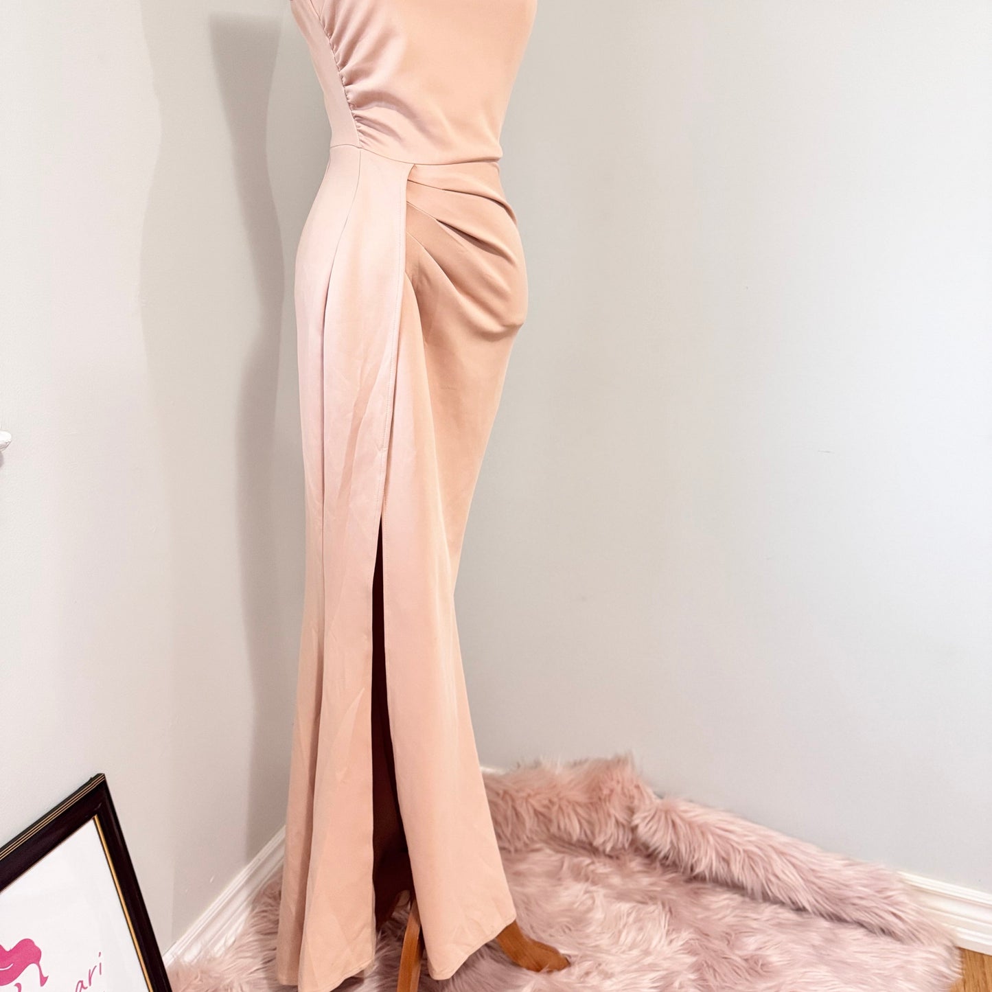 Make an unforgettable entrance in this stunning one-shoulder gown, designed to accentuate your curves with effortless grace. Featuring a sleek asymmetrical neckline and elegantly draped side ruching, this dress flatters from every angle. The high-slit detail adds just the right touch of allure, making it the perfect choice for weddings, formal events, or any special occasion where you want to shine. The soft blush hue complements a variety of skin tones, ensuring a timeless and sophisticated look.