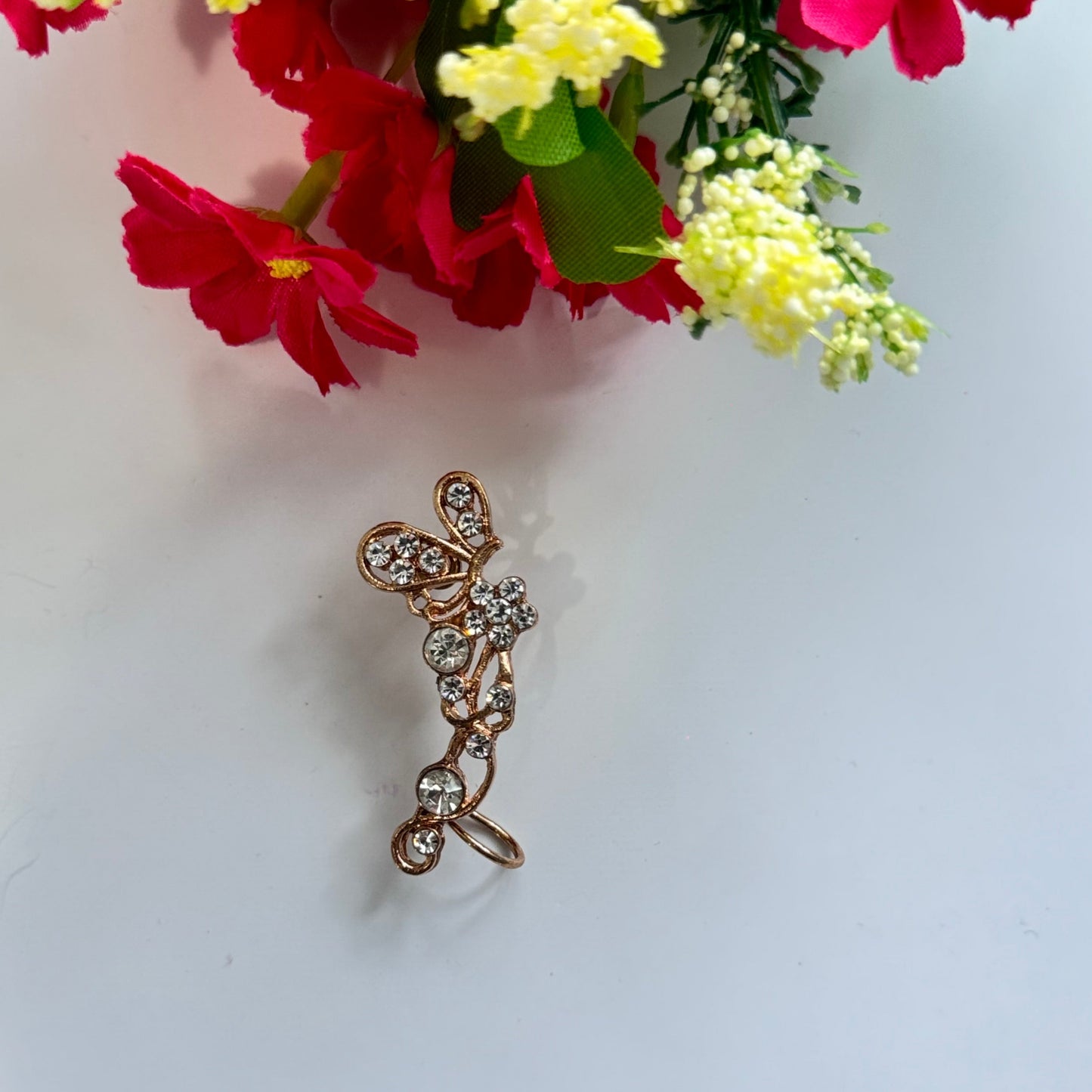 Elevate your earring collection with this exquisite, gold-tone crystal butterfly ear cuff, a true embodiment of elegance and sophistication.