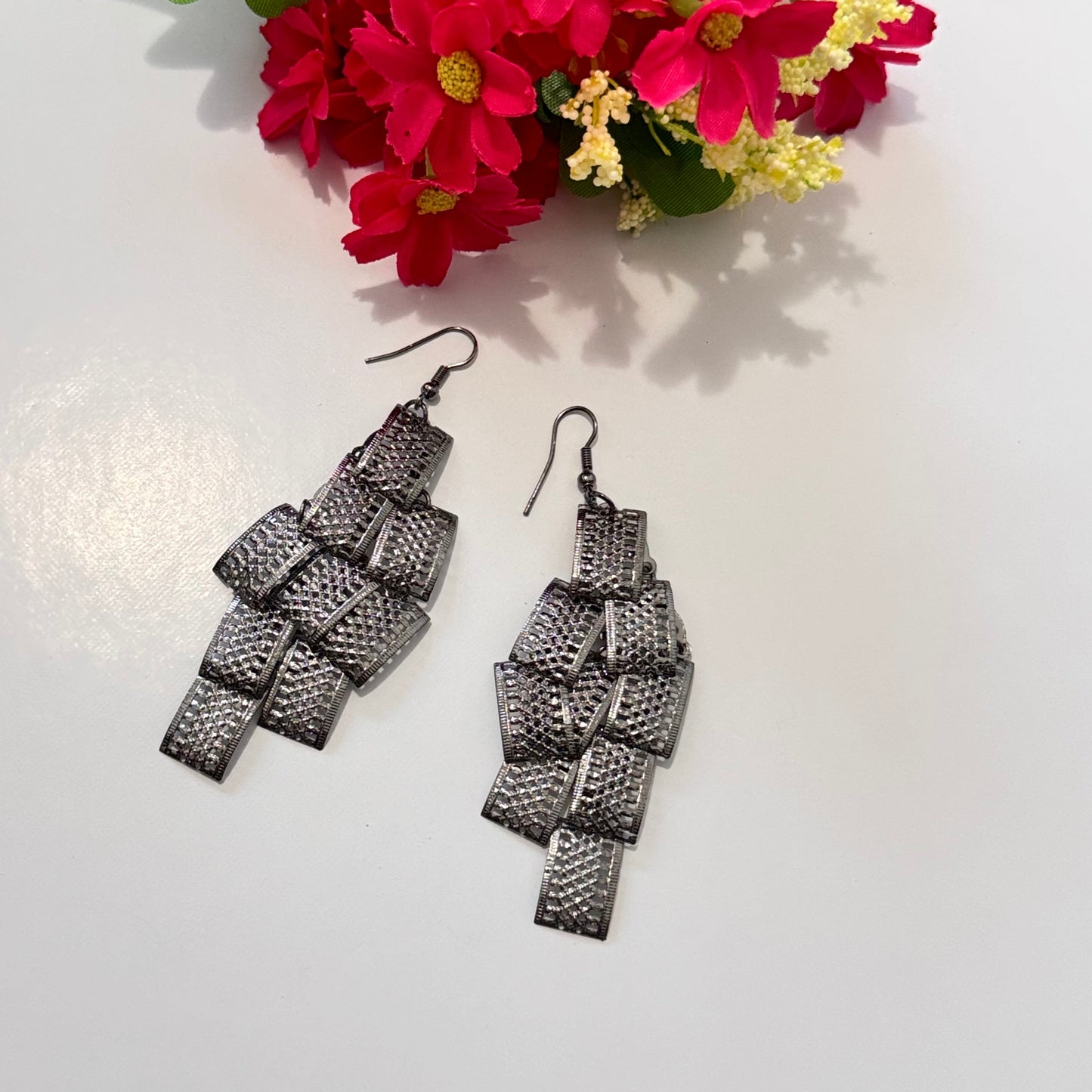 Unleash your bold and elegant side with these statement metal cascade earrings—a perfect blend of modern sophistication and timeless charm. Crafted with intricate, textured metal loops, these lightweight yet striking earrings exude a mesmerizing shimmer with every movement, making them the ultimate head-turner.