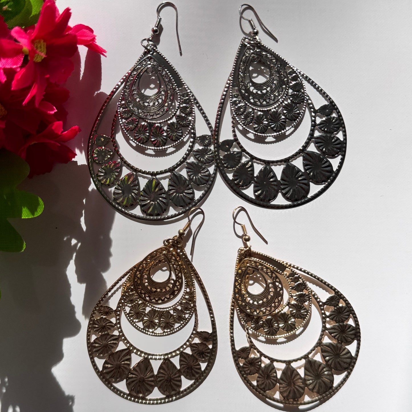 Elevate your style with our Intricate Filigree Teardrop Earrings, a breathtaking fusion of elegance and bohemian charm. Designed with delicate floral-inspired cutouts and cascading layered arches, these statement earrings capture the essence of timeless beauty and modern sophistication.