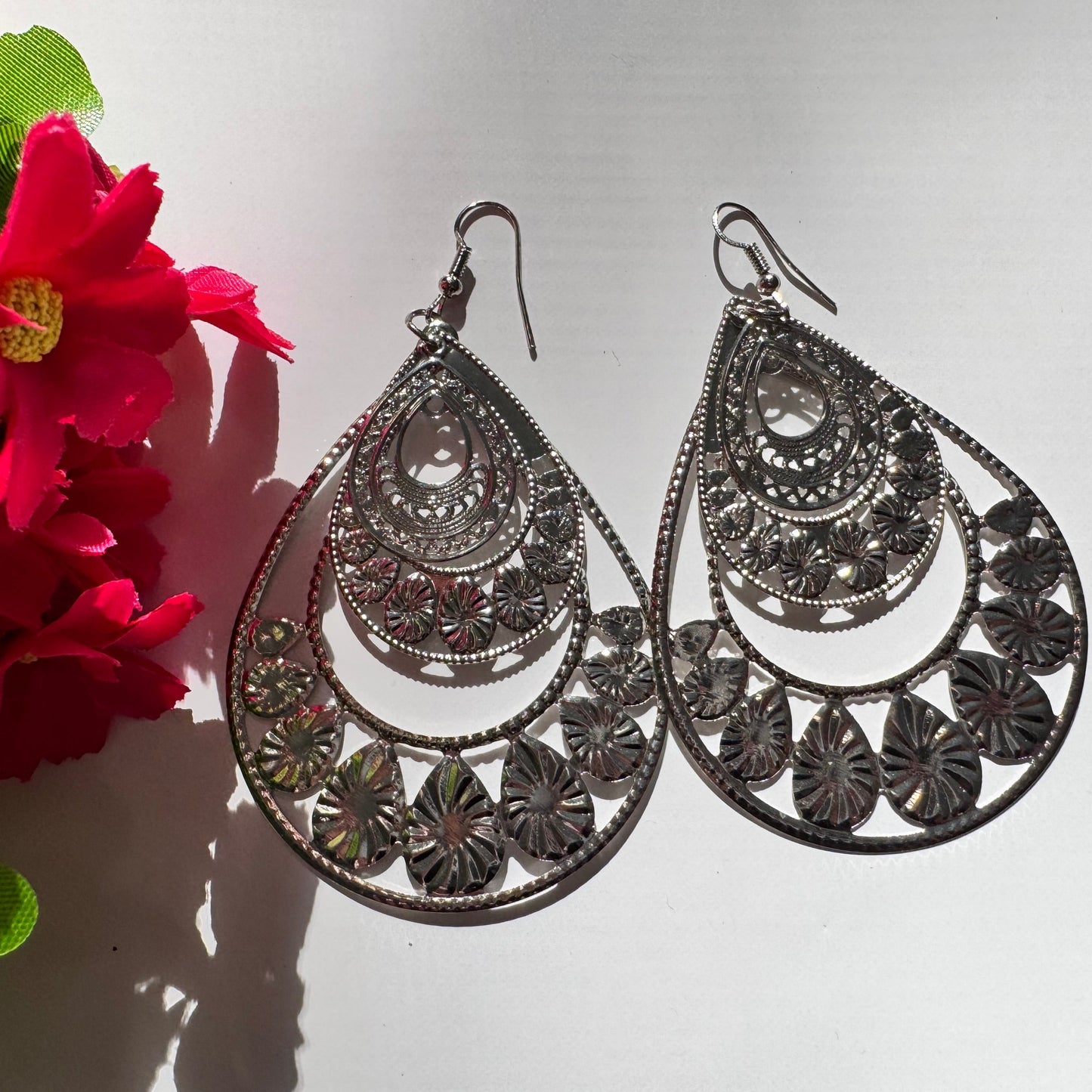 Elevate your style with our Intricate Filigree Teardrop Earrings, a breathtaking fusion of elegance and bohemian charm. Designed with delicate floral-inspired cutouts and cascading layered arches, these statement earrings capture the essence of timeless beauty and modern sophistication.