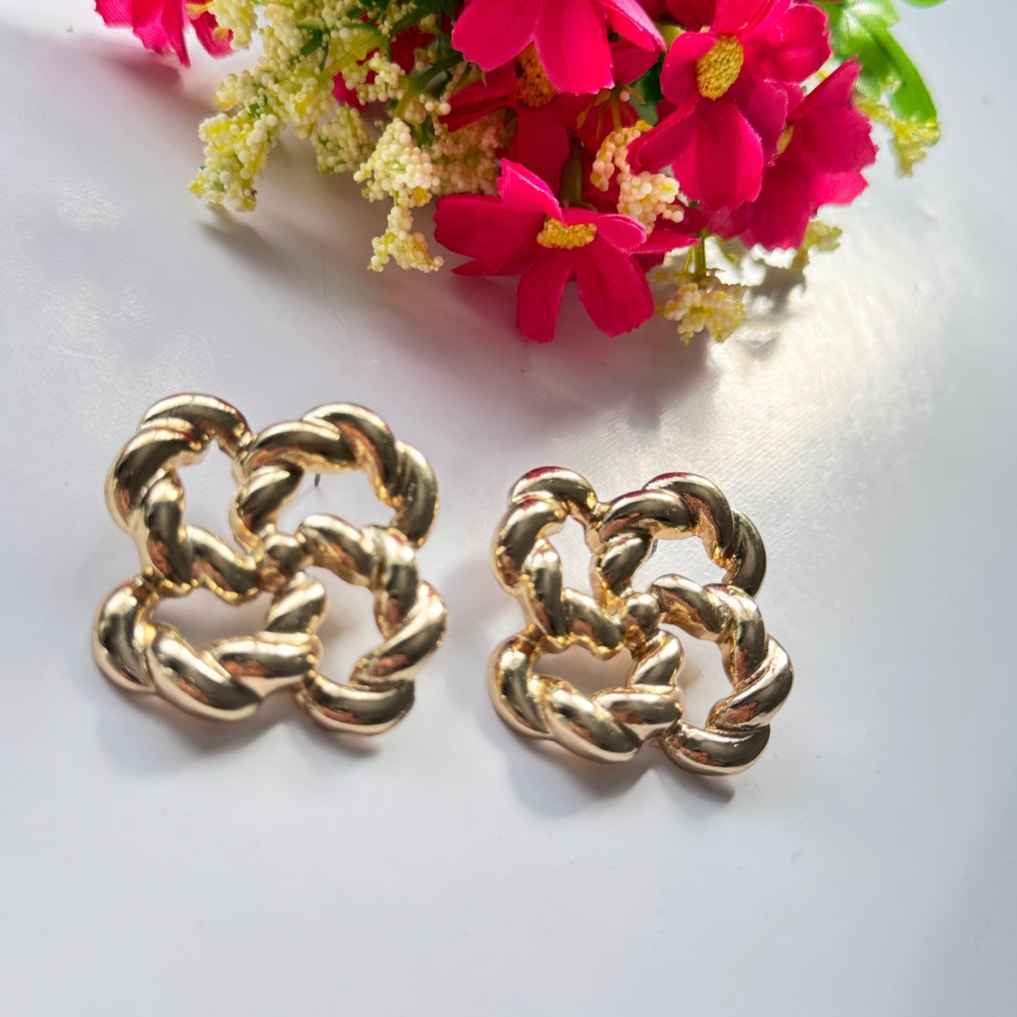 Make a bold and sophisticated statement with these exquisite gold-tone knot earrings, designed to add a touch of timeless elegance to any outfit. Featuring an intricate twisted rope design in a chic floral-inspired shape, these earrings radiate luxury and refinement.