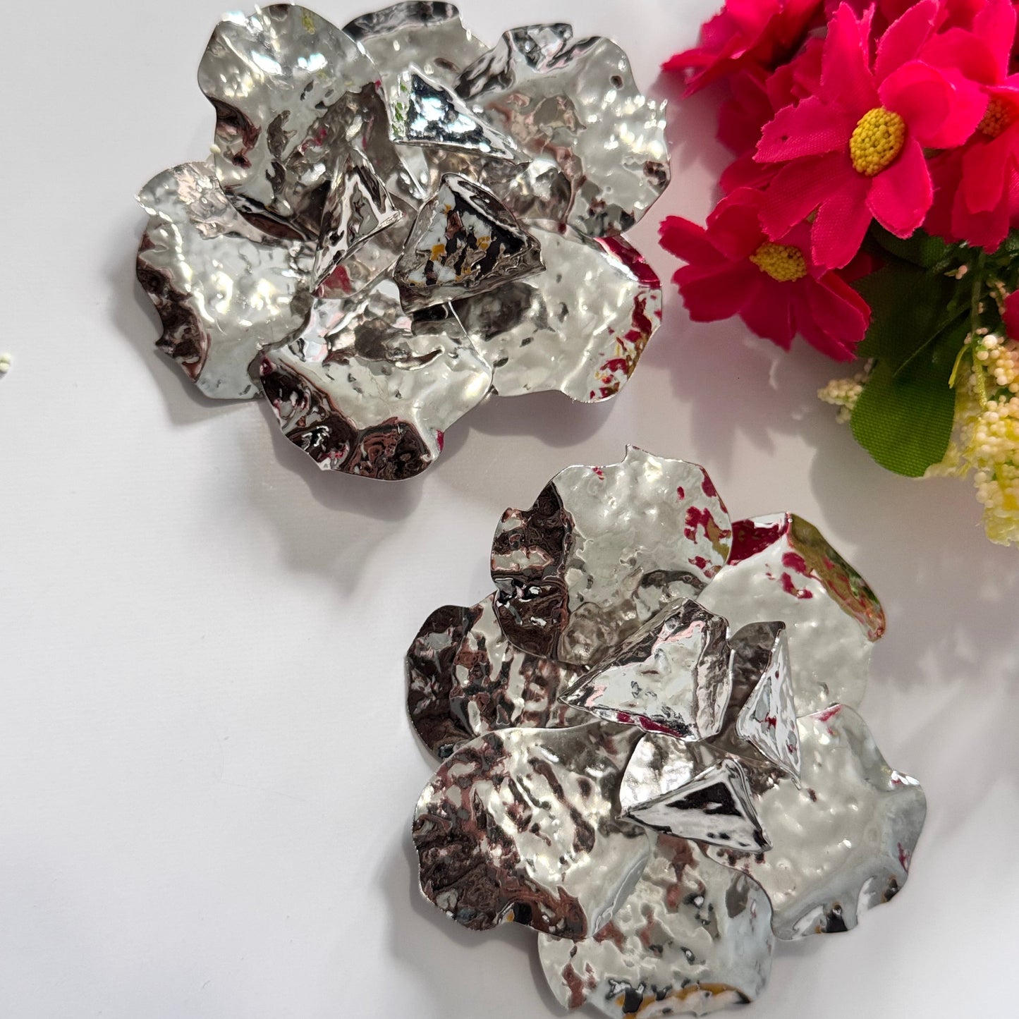 Dare to dazzle with these stunning Hammered Silver Floral Statement Earrings, a true showstopper for modern fashionistas! Crafted with a sculptural, textured metallic finish, these oversized floral earrings radiate contemporary glamour with an artistic edge