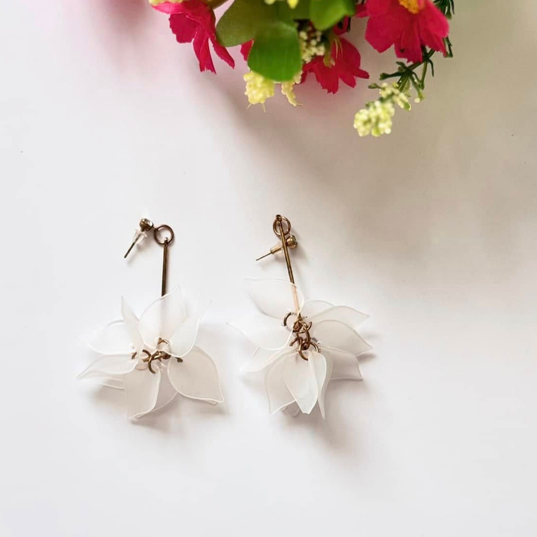Embrace nature-inspired elegance with these stunning floral drop earrings, designed to add a fresh and feminine touch to any outfit. Featuring delicate, layered petals in rich emerald green, classic white, and vibrant orange, these statement pieces exude charm and sophistication. Suspended from sleek gold-tone accents, they offer a perfect balance of bold color and lightweight comfort.