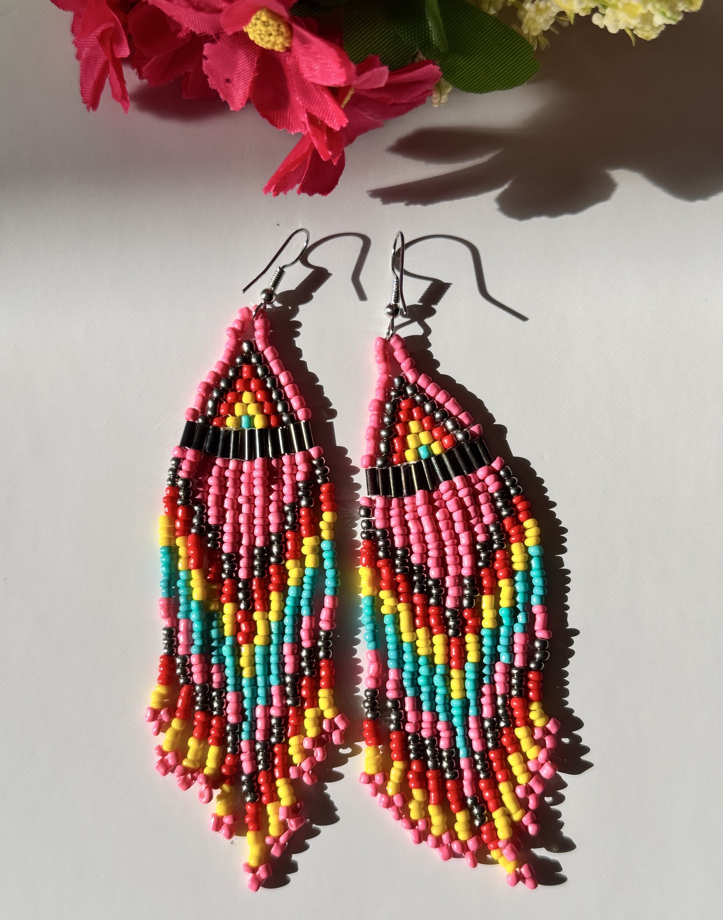 Elevate your style with these beaded earrings, a perfect blend of vibrant colors and intricate craftsmanship. Designed for bold, confident individuals, these statement earrings are inspired by traditional beadwork, featuring a chevron zigzag pattern that adds a unique artistic touch.