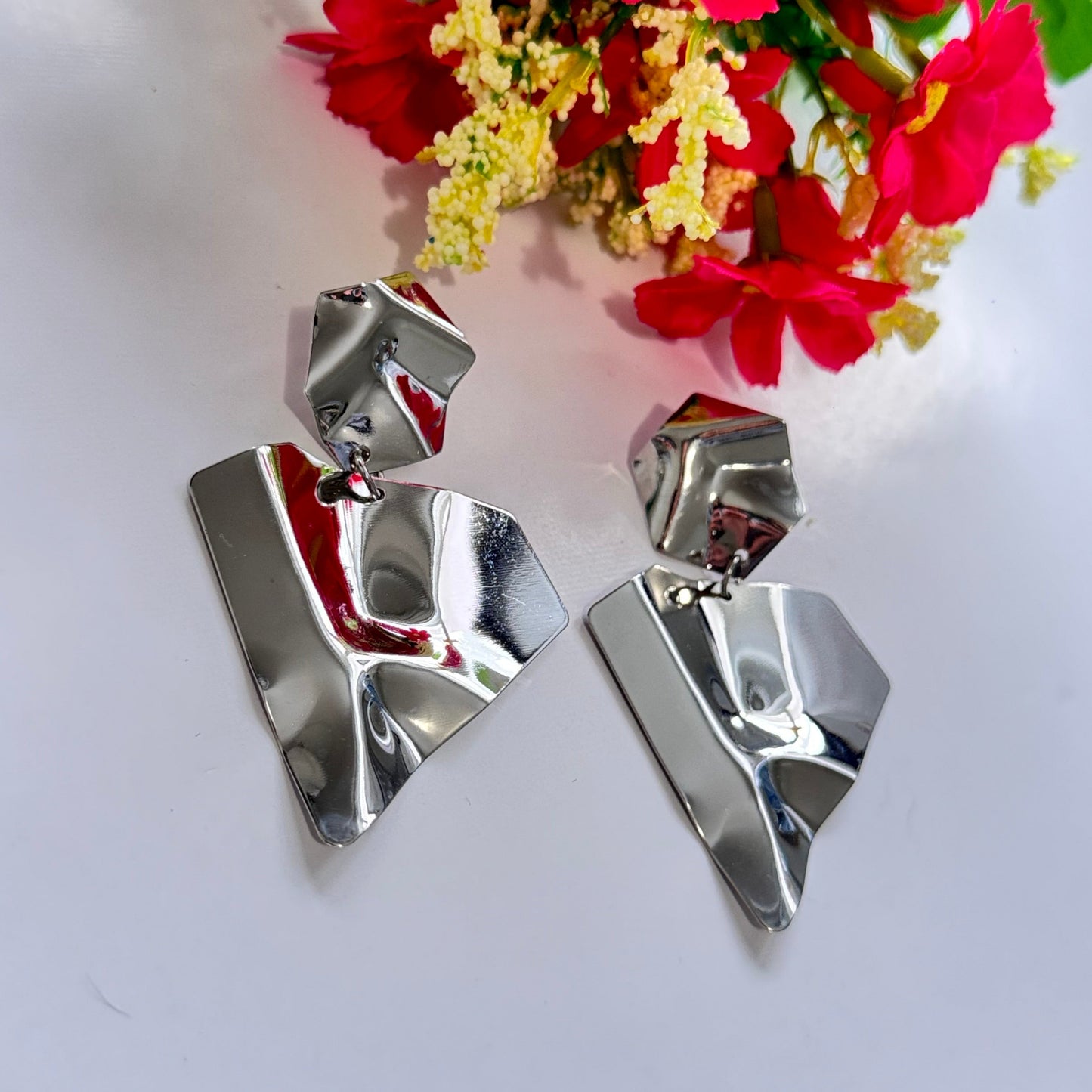 Make a bold statement with these ultra-modern, sculpted silver earrings, designed for those who love edgy sophistication. Featuring a high-shine, crumpled metal effect, these geometric statement pieces exude contemporary elegance with an artistic twist.