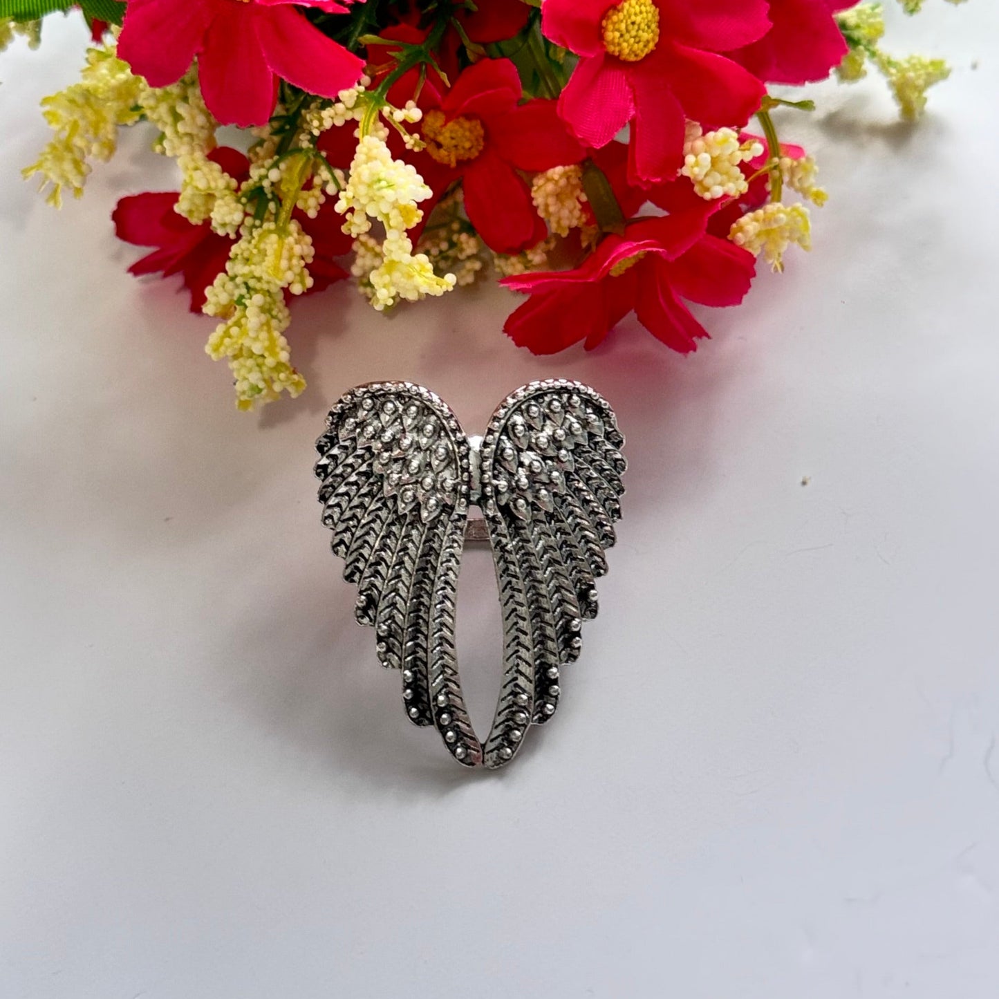 Unleash your inner angel with this breathtaking silver wing statement ring, a true masterpiece of elegance and symbolism. Featuring intricately detailed feathers with a radiant metallic finish, this bold accessory embodies strength, freedom, and divine beauty. The dramatic open-wing design gracefully wraps around your finger, creating a striking look that is both powerful and enchanting.
Size: 8
Diameter: 1.8cm