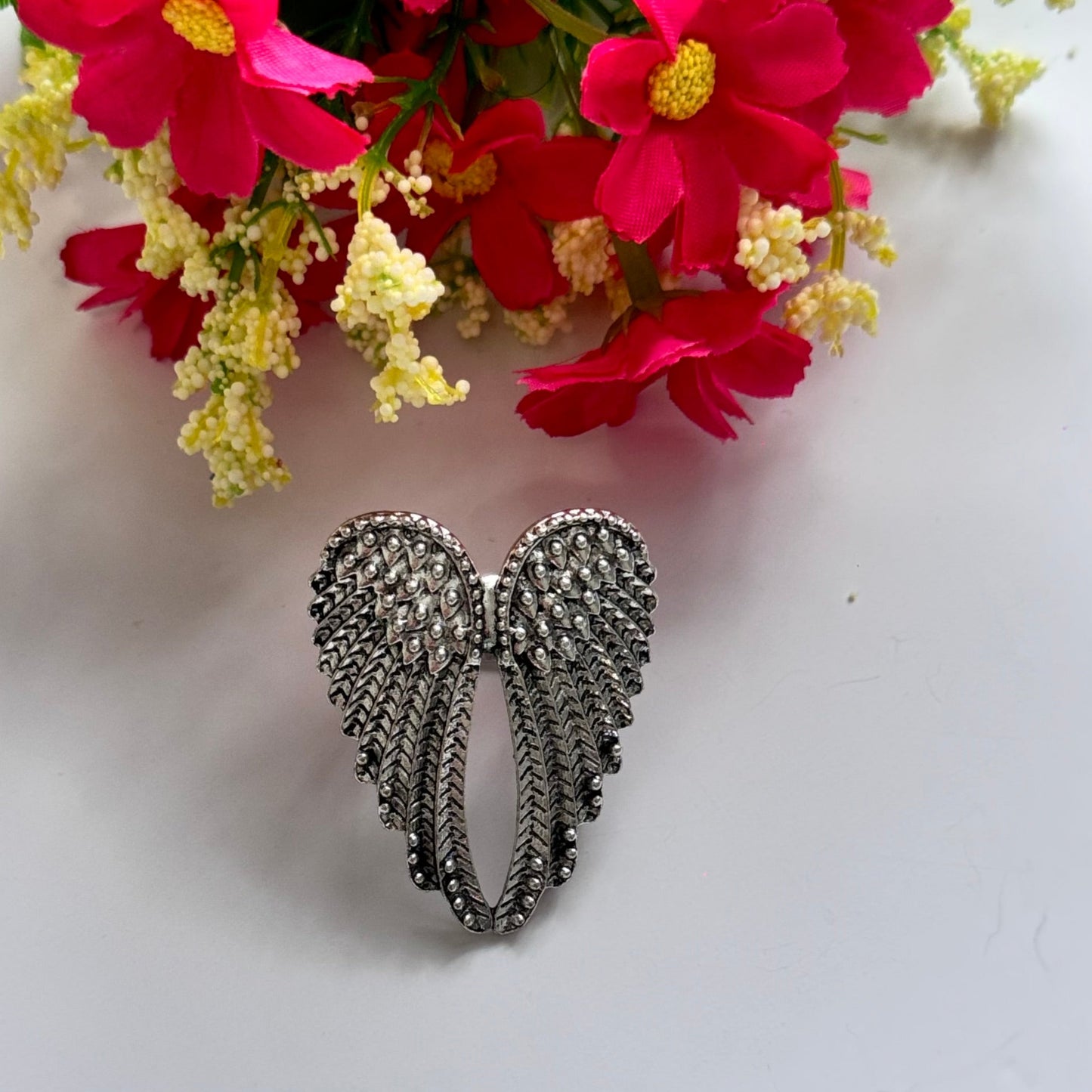 Unleash your inner angel with this breathtaking silver wing statement ring, a true masterpiece of elegance and symbolism. Featuring intricately detailed feathers with a radiant metallic finish, this bold accessory embodies strength, freedom, and divine beauty. The dramatic open-wing design gracefully wraps around your finger, creating a striking look that is both powerful and enchanting.
Size: 8
Diameter: 1.8cm