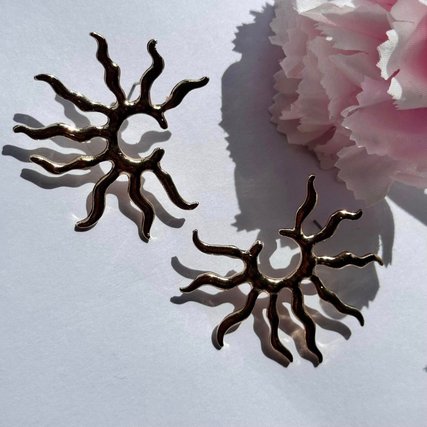 Radiate confidence with these gold sunburst statement earrings – a bold, celestial-inspired accessory for any occasion.