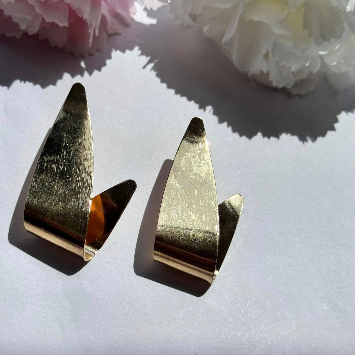 Bold and modern gold earrings – a statement piece that elevates any look with effortless elegance.