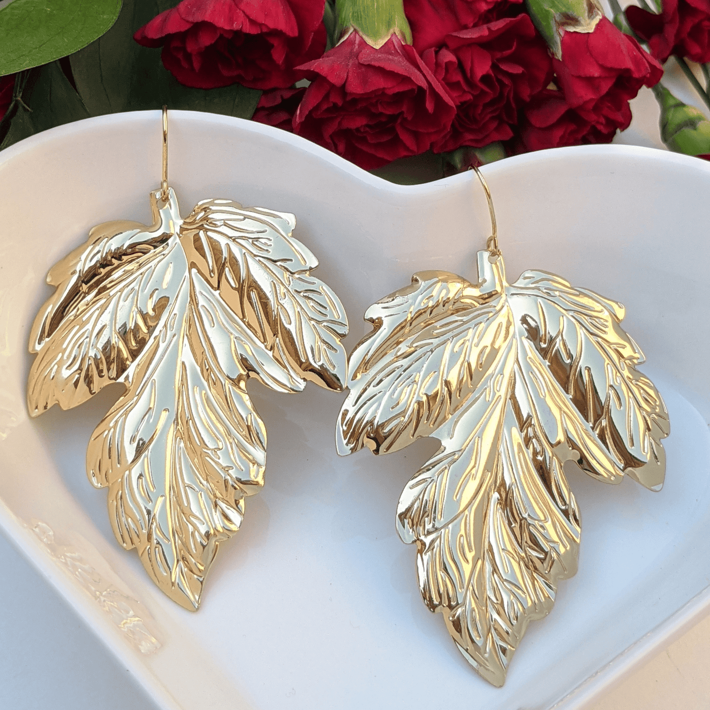 Stunning gold leaf statement earrings with intricate detailing—perfect for an elegant, nature-inspired look.