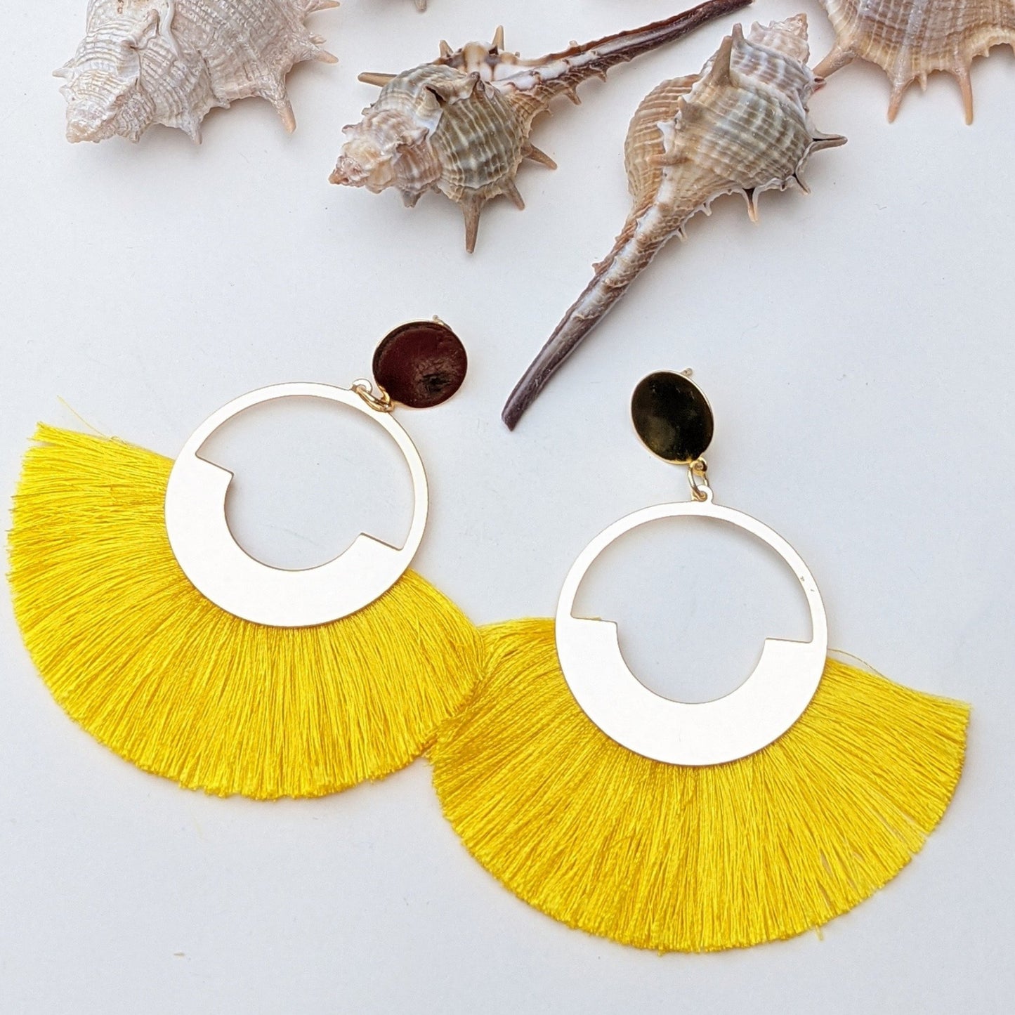Dolly is a beautiful bold fringe tassel earring! This bold tassel earrings featuring lots of vibrant colors hung on a textural fringe metal, perfect to match and add as a statement earring to any outfit. You can use this fan tassel earring to add extra fun colors to your looks.