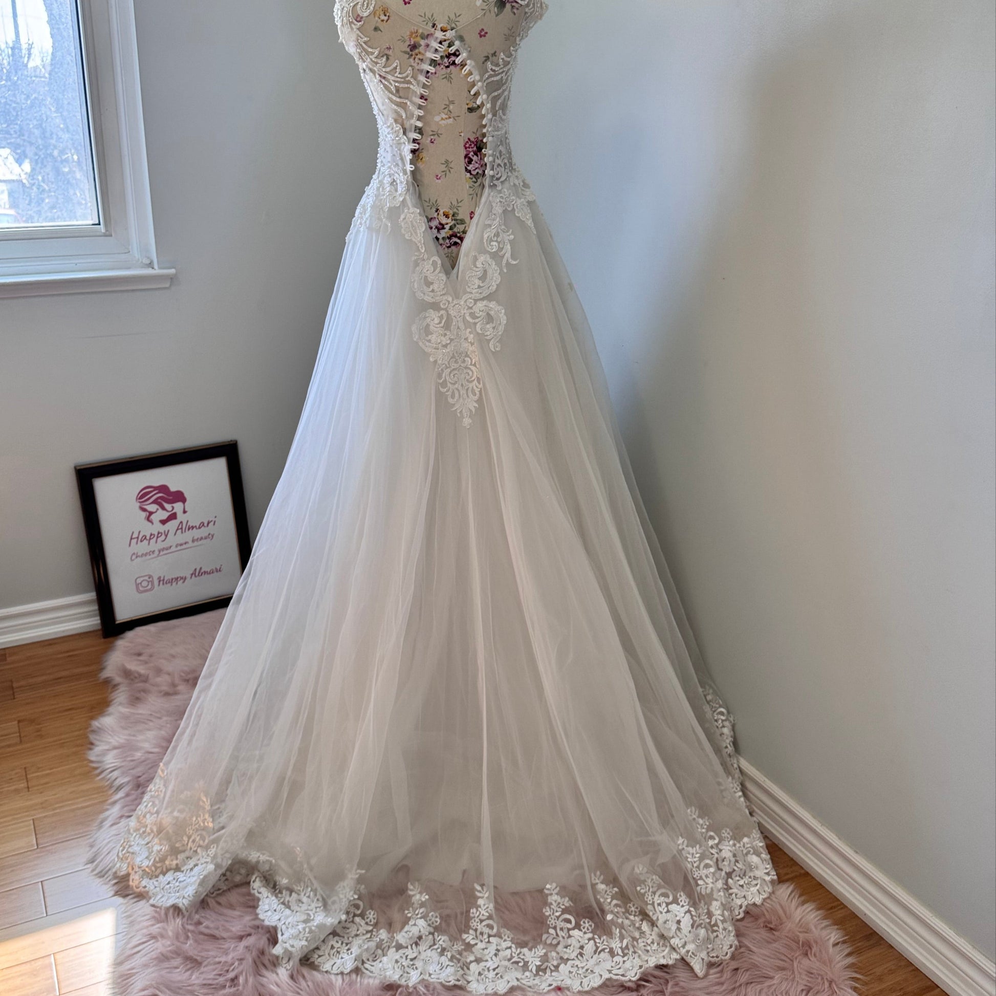 Ethereal elegance meets timeless romance in this breathtaking bridal gown, designed to make you feel like an absolute vision on your special day. Featuring an intricately beaded bodice with delicate lace appliqués cascading onto a flowing tulle skirt, this gown embodies grace and sophistication. The illusion off-shoulder neckline and sweetheart design create a captivating silhouette, while the soft, airy layers add a dreamy, fairytale-like effect with every step. 