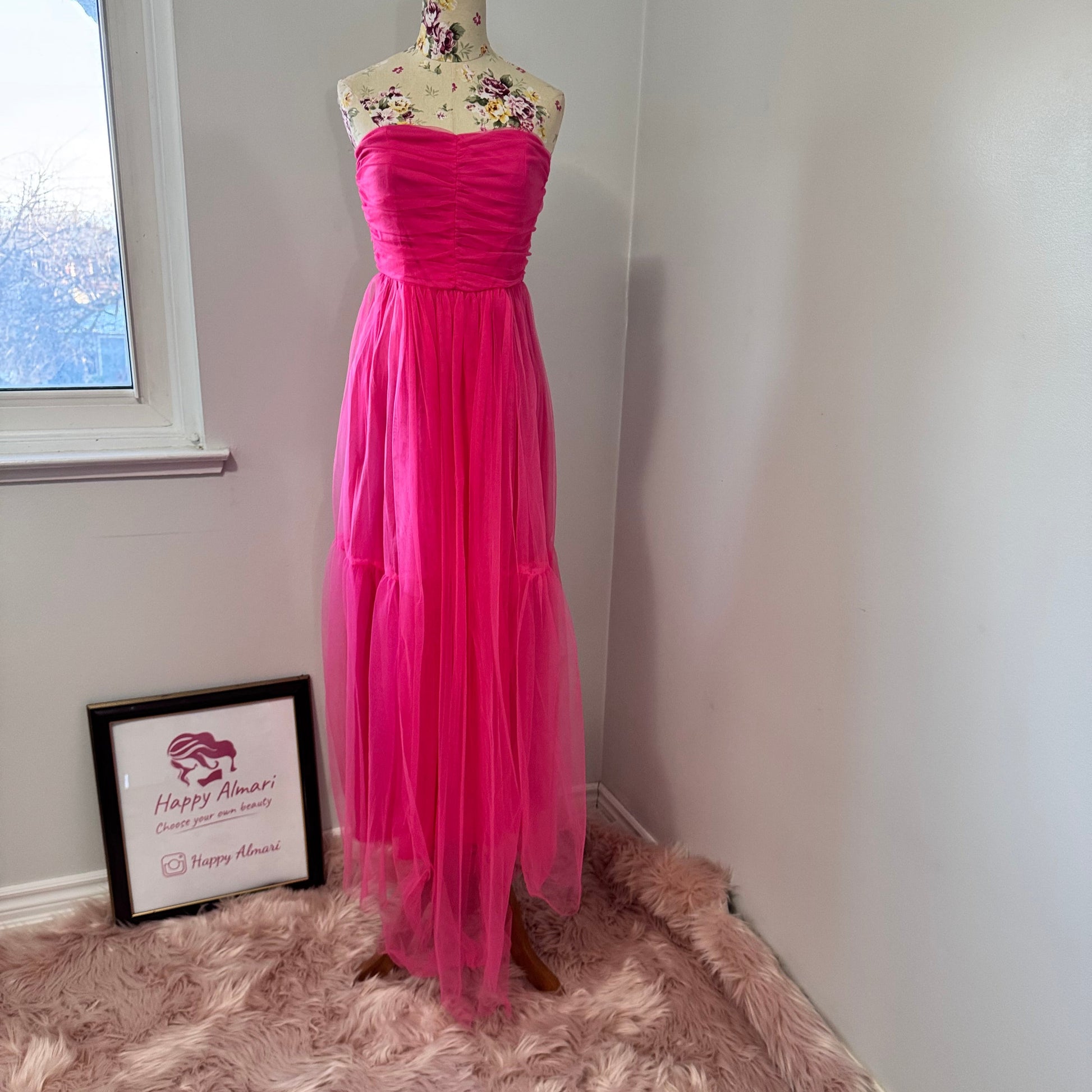Turn heads and steal the spotlight in this breathtaking hot pink tulle gown, designed for those who dare to stand out. Featuring a strapless ruched bodice that flatters every curve and a flowing layered tulle skirt that moves with elegance, this dress is the ultimate statement piece for proms, weddings, gala nights, or any special occasion. The vibrant color radiates confidence and charm, making you the center of attention wherever you go. 