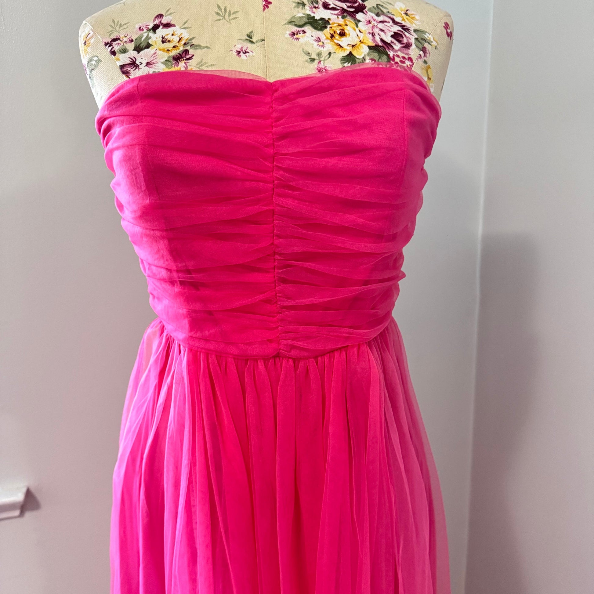 Turn heads and steal the spotlight in this breathtaking hot pink tulle gown, designed for those who dare to stand out. Featuring a strapless ruched bodice that flatters every curve and a flowing layered tulle skirt that moves with elegance, this dress is the ultimate statement piece for proms, weddings, gala nights, or any special occasion. The vibrant color radiates confidence and charm, making you the center of attention wherever you go. 