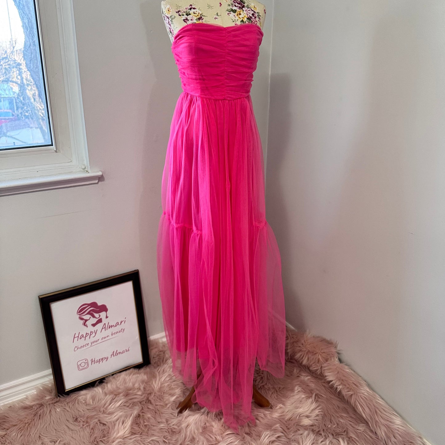 Turn heads and steal the spotlight in this breathtaking hot pink tulle gown, designed for those who dare to stand out. Featuring a strapless ruched bodice that flatters every curve and a flowing layered tulle skirt that moves with elegance, this dress is the ultimate statement piece for proms, weddings, gala nights, or any special occasion. The vibrant color radiates confidence and charm, making you the center of attention wherever you go. 