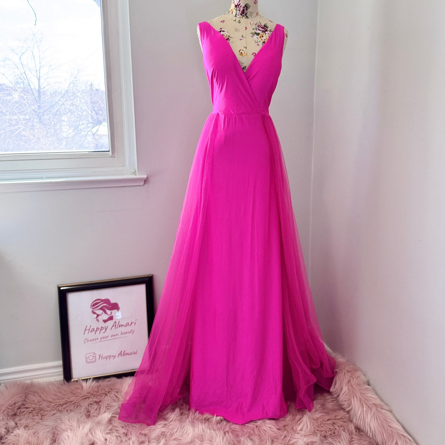 Turn heads and steal the spotlight in this breathtaking hot pink evening gown, designed to make every moment unforgettable. Featuring a stunning deep V-neckline and a flowing tulle overlay, this dress embodies elegance, confidence, and timeless charm. 