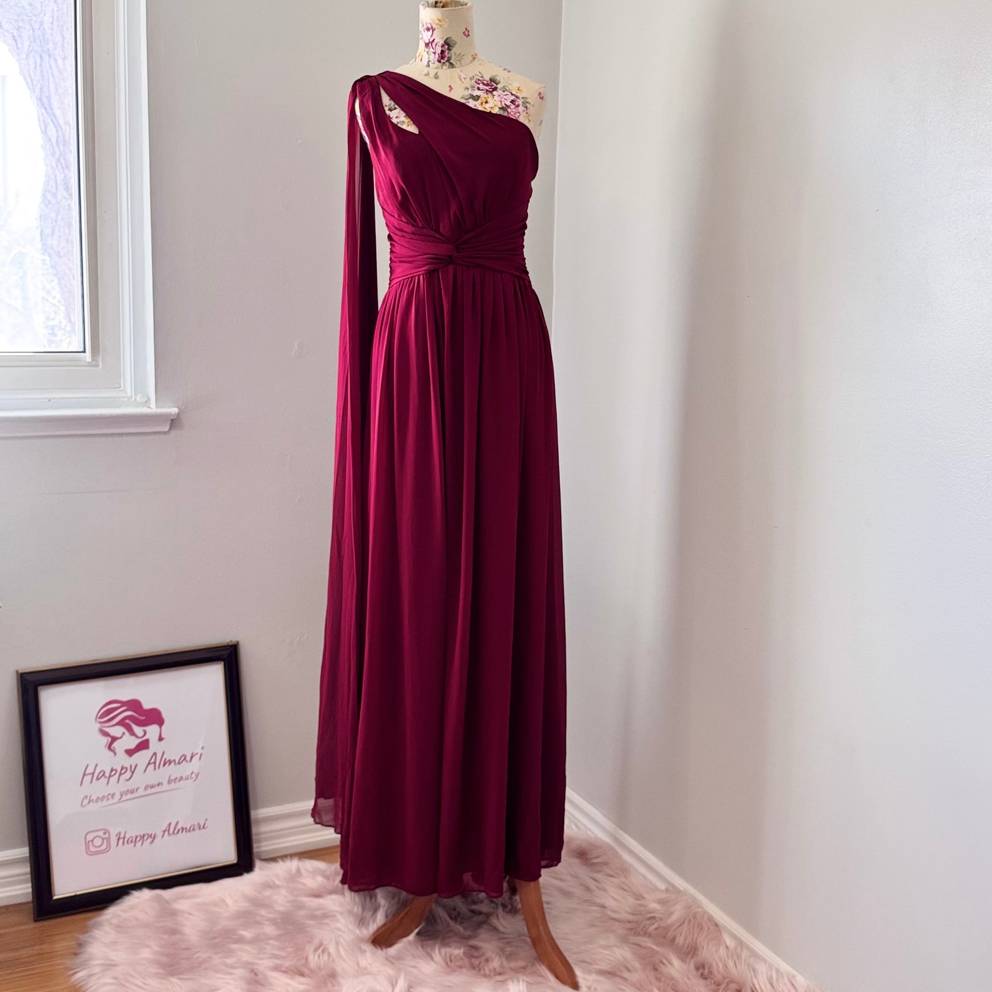 Elevate your wardrobe with this breathtaking one-shoulder gown in a deep wine hue, designed to make a statement at any formal event. Crafted from flowing chiffon, this dress drapes elegantly, featuring a cinched waist for a flattering silhouette and a striking sheer drape that adds an ethereal touch.