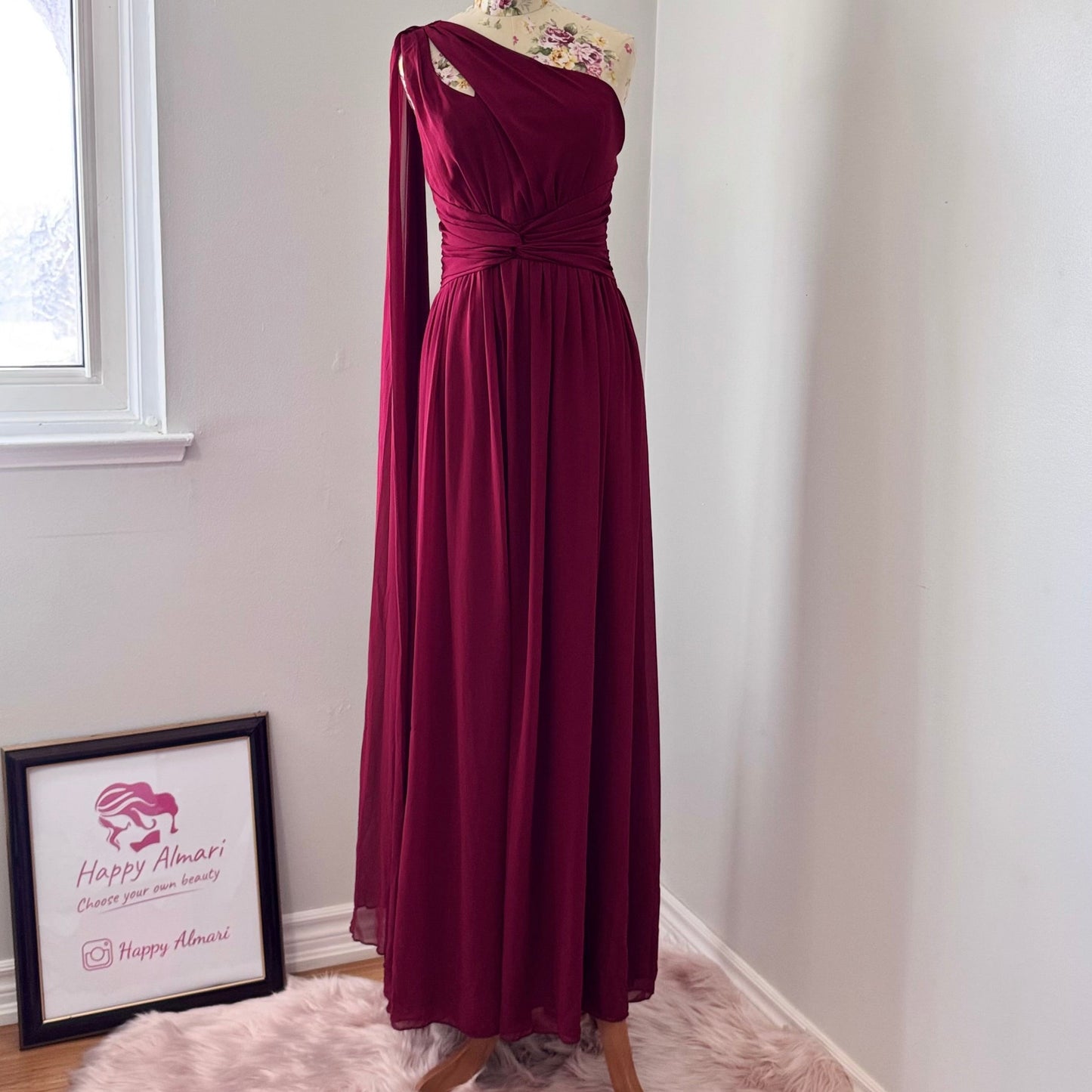 Elevate your wardrobe with this breathtaking one-shoulder gown in a deep wine hue, designed to make a statement at any formal event. Crafted from flowing chiffon, this dress drapes elegantly, featuring a cinched waist for a flattering silhouette and a striking sheer drape that adds an ethereal touch.