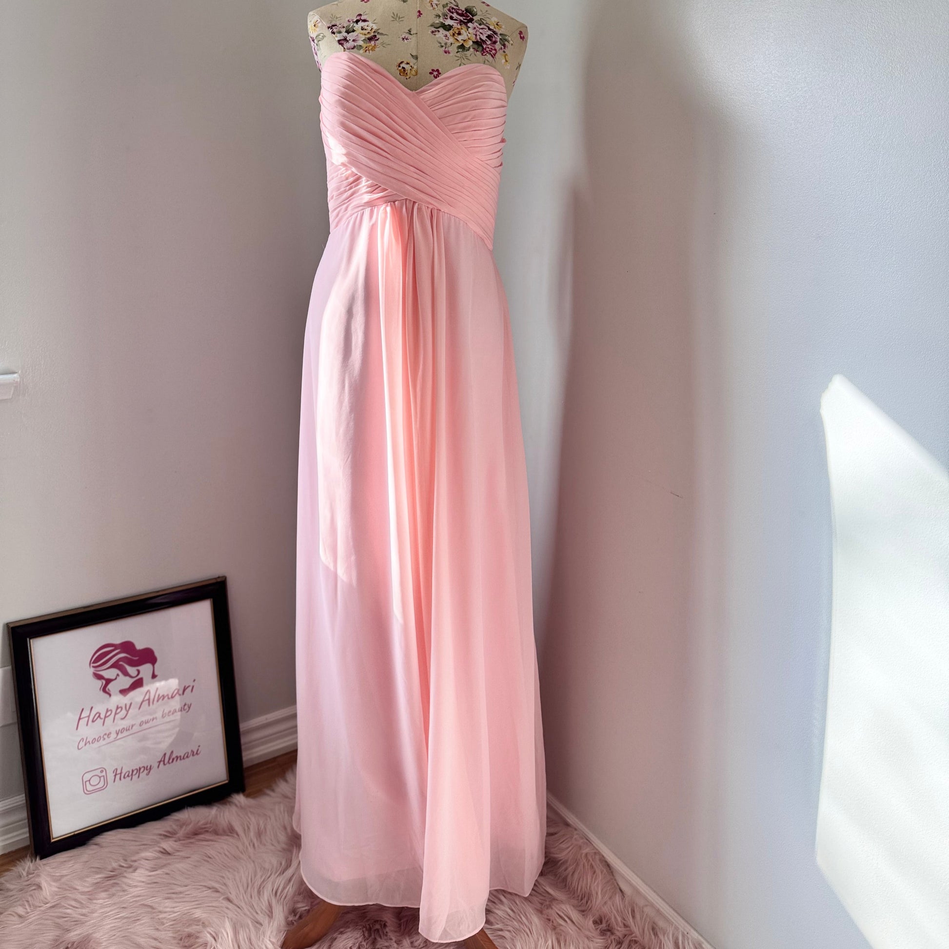 This enchanting blush pink gown is the epitome of timeless elegance, designed to make you feel effortlessly radiant at any special occasion. Featuring a flattering sweetheart neckline with delicately ruched detailing, this dress cascades into a flowy chiffon skirt, creating a dreamy, ethereal silhouette. 
