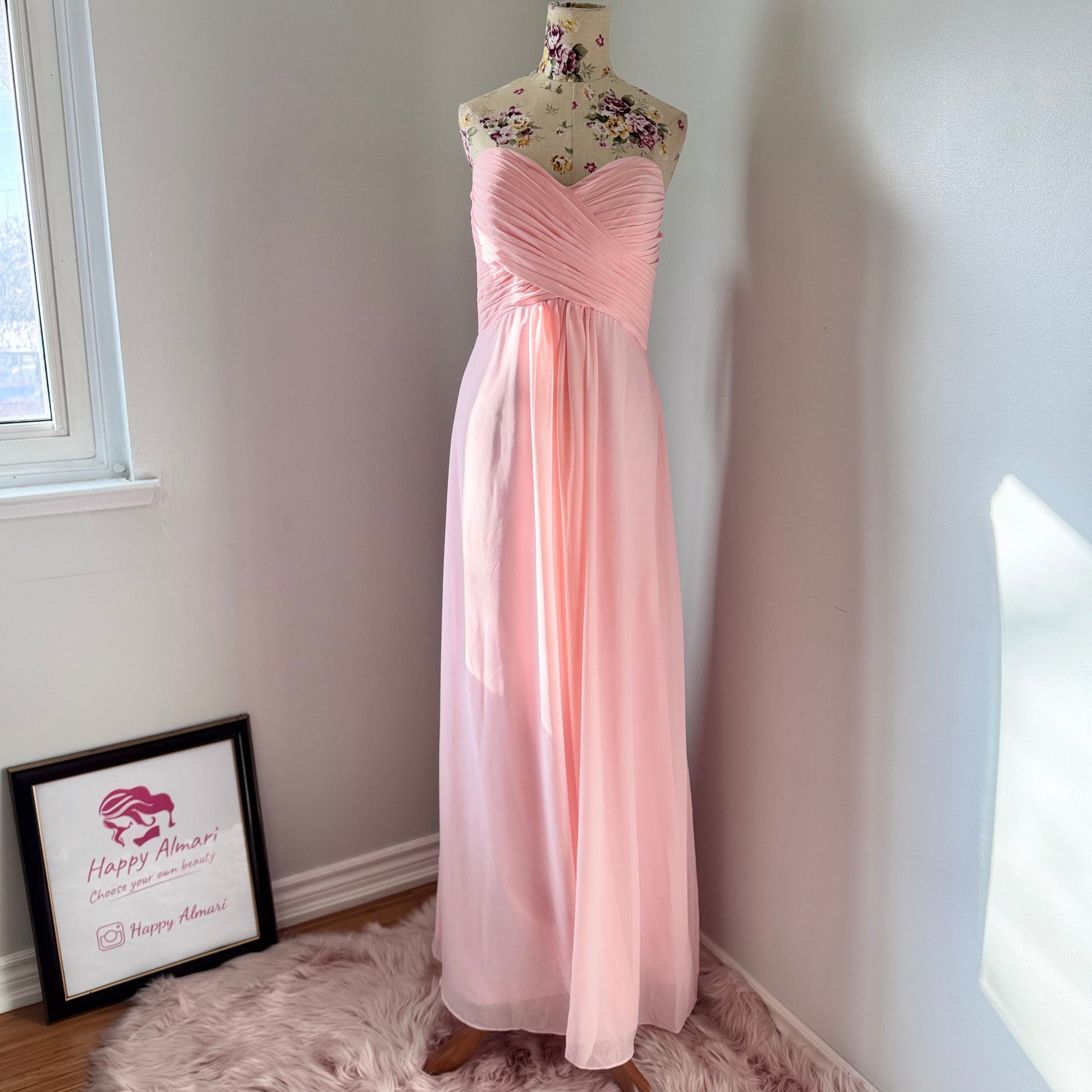 This enchanting blush pink gown is the epitome of timeless elegance, designed to make you feel effortlessly radiant at any special occasion. Featuring a flattering sweetheart neckline with delicately ruched detailing, this dress cascades into a flowy chiffon skirt, creating a dreamy, ethereal silhouette. 