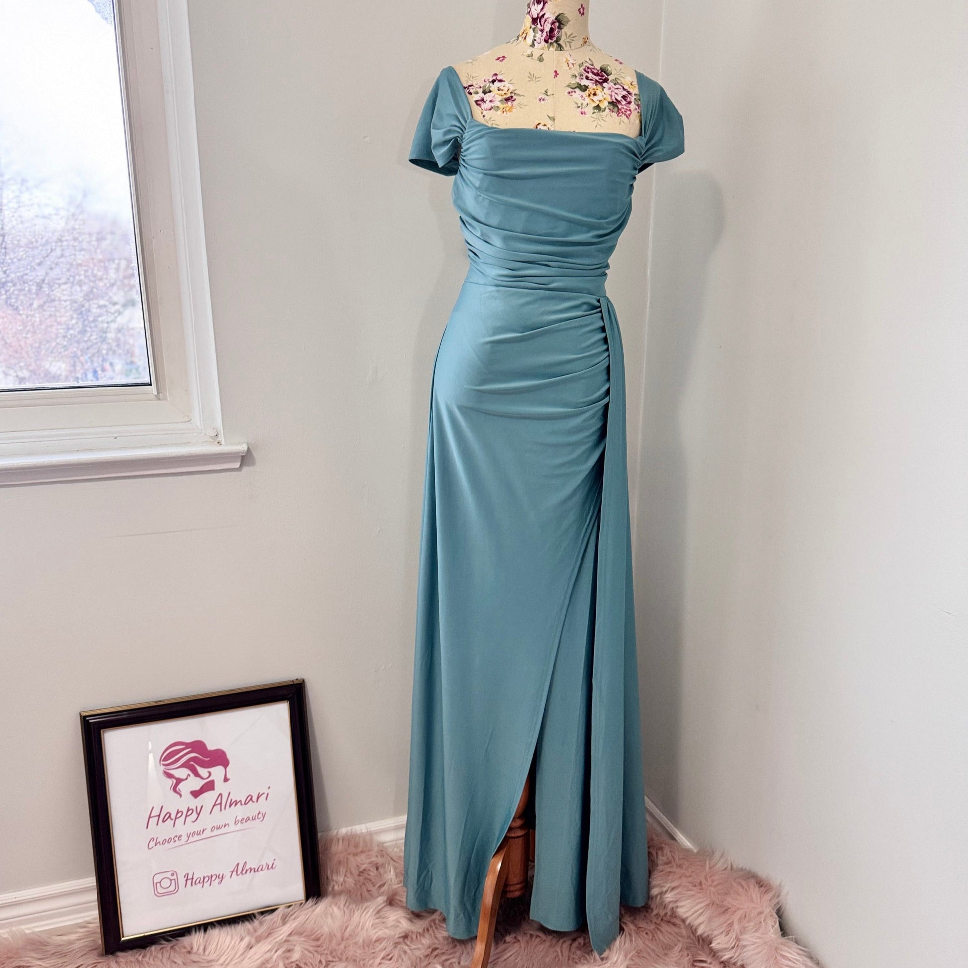 Turn heads with this stunning ocean-blue draped evening gown, designed to flatter every curve with its elegant ruched bodice and flowing silhouette. Featuring an off-shoulder neckline and a sultry side slit, this dress is perfect for weddings, formal events, and special occasions where making a statement is a must! The smooth, high-quality fabric offers a graceful drape, ensuring you move with confidence and poise.