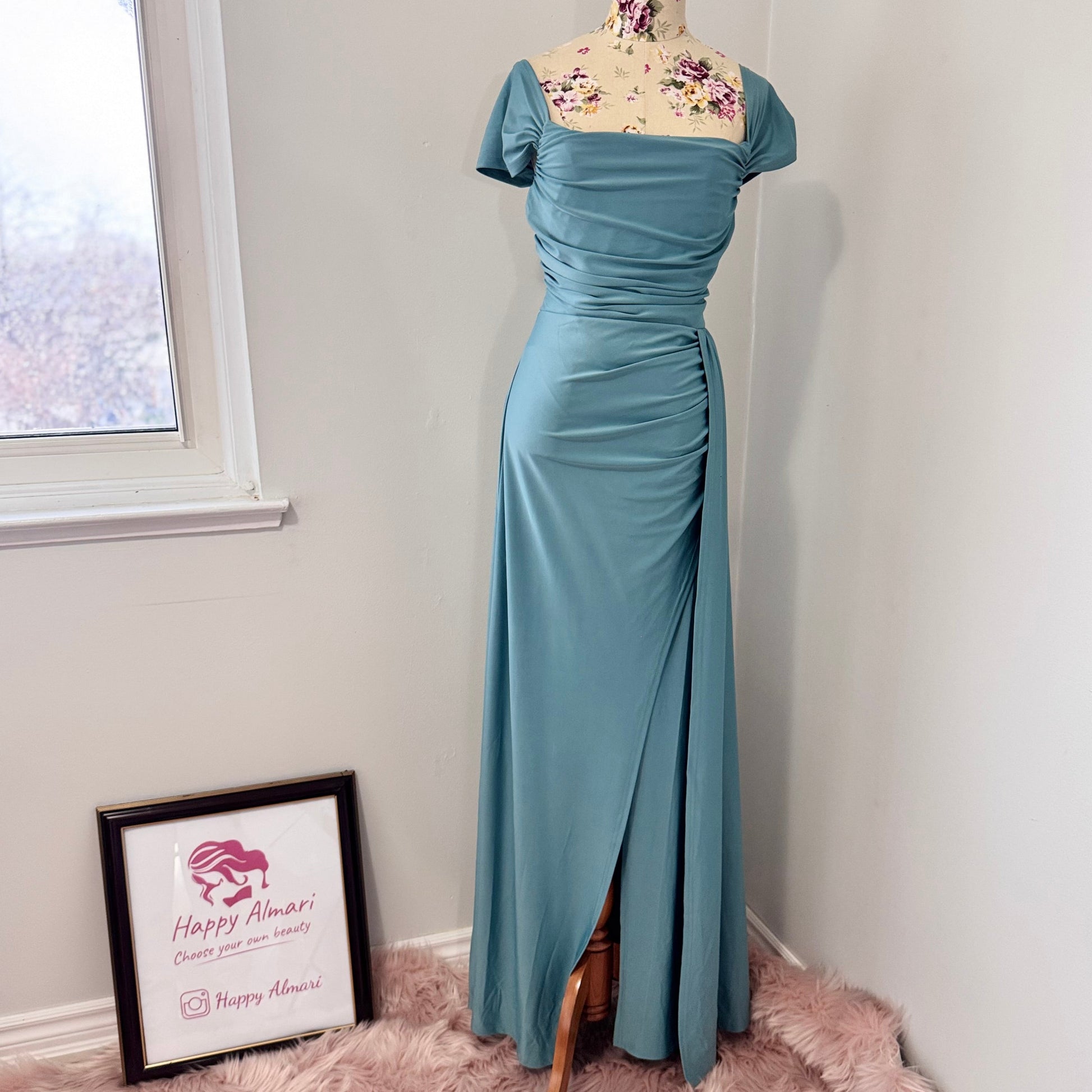 Turn heads with this stunning ocean-blue draped evening gown, designed to flatter every curve with its elegant ruched bodice and flowing silhouette. Featuring an off-shoulder neckline and a sultry side slit, this dress is perfect for weddings, formal events, and special occasions where making a statement is a must! The smooth, high-quality fabric offers a graceful drape, ensuring you move with confidence and poise.