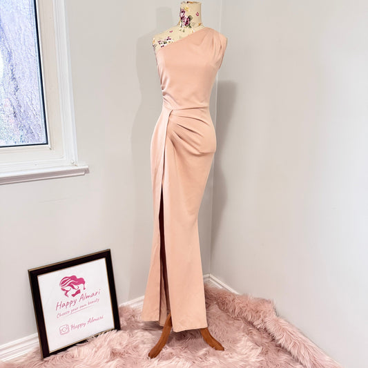 Make an unforgettable entrance in this stunning one-shoulder gown, designed to accentuate your curves with effortless grace. Featuring a sleek asymmetrical neckline and elegantly draped side ruching, this dress flatters from every angle. The high-slit detail adds just the right touch of allure, making it the perfect choice for weddings, formal events, or any special occasion where you want to shine. The soft blush hue complements a variety of skin tones, ensuring a timeless and sophisticated look. 