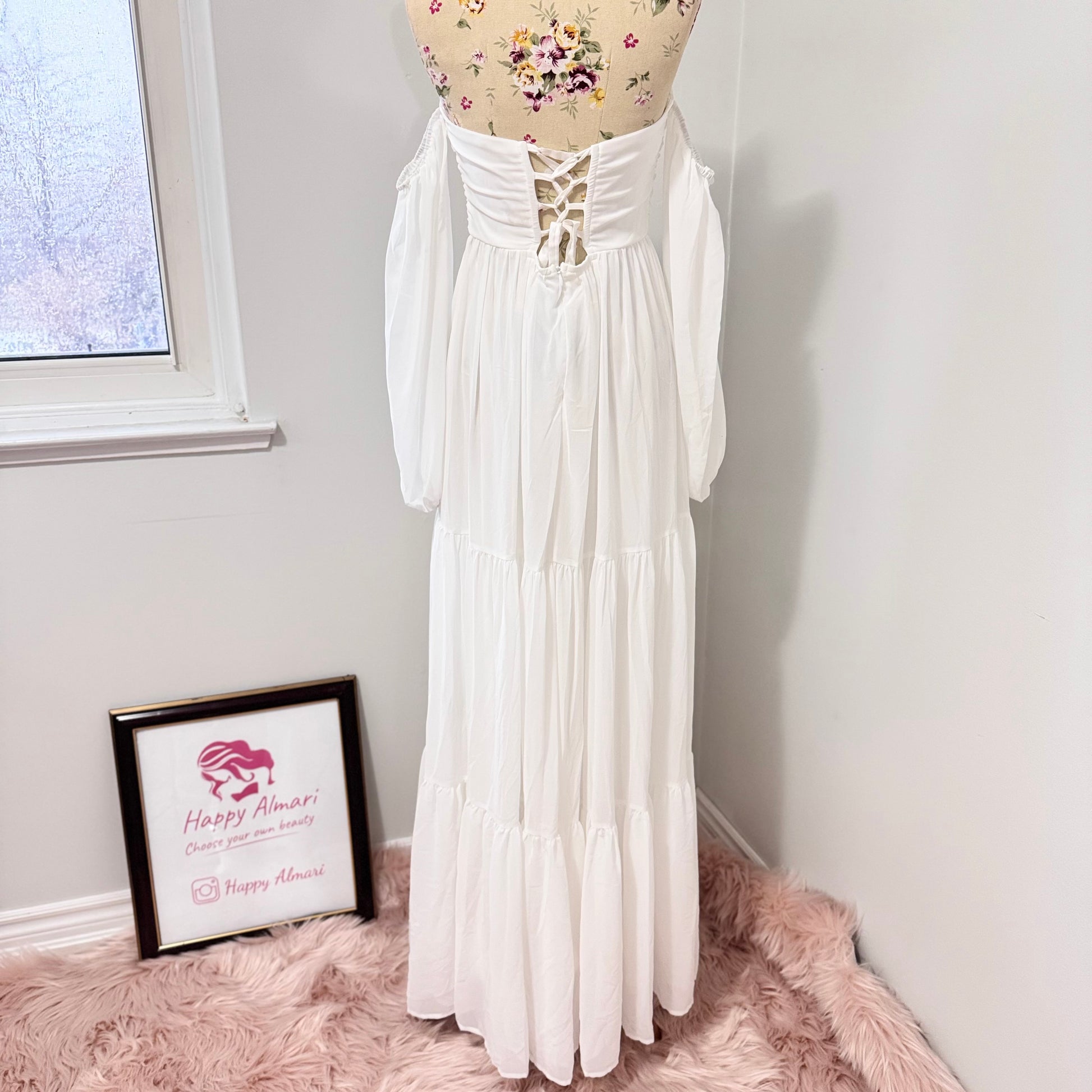 Step into effortless elegance with this stunning off-shoulder white maxi dress, designed to make you feel like a goddess at any event! Featuring a flattering ruched bodice, romantic flowy tiered skirt, and long billowy sleeves.