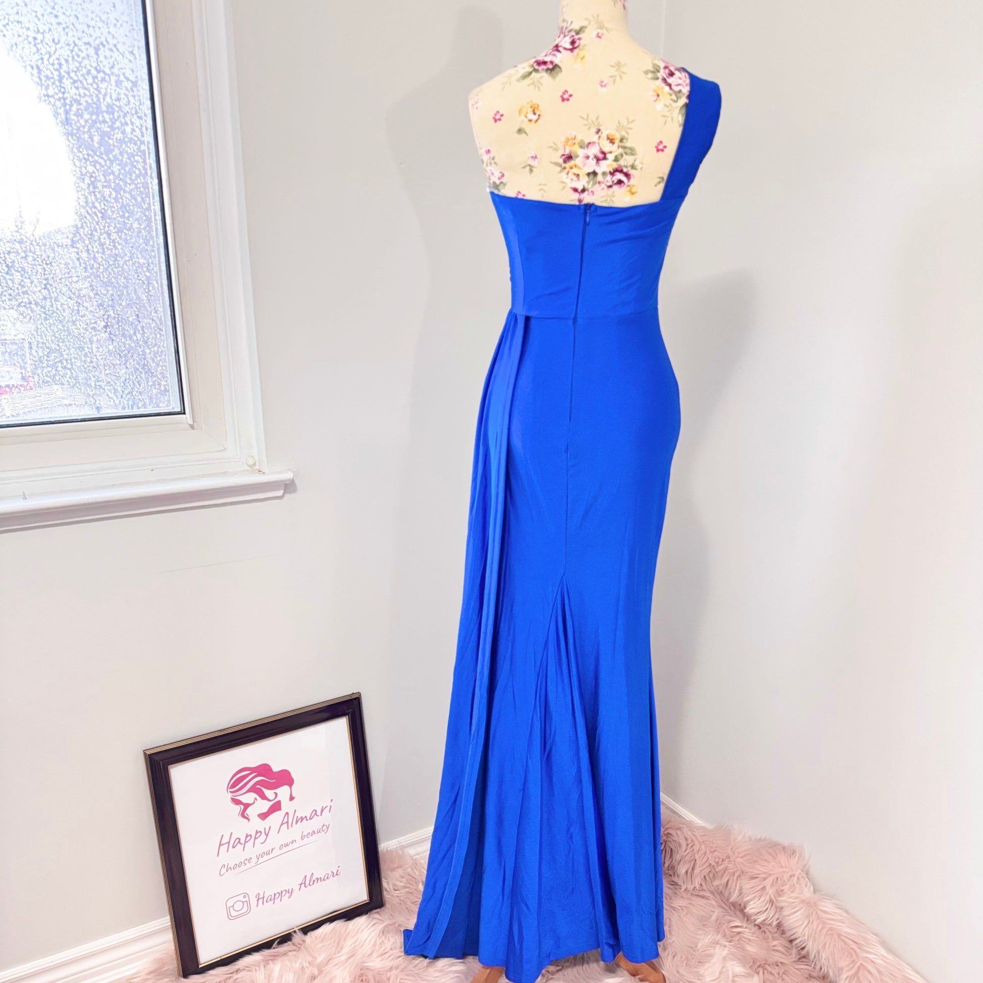 Step into elegance with this stunning cobalt blue one-shoulder gown, designed to turn heads at any special occasion. Featuring a flattering ruched bodice that accentuates your curves and a flowing floor-length silhouette with a dramatic side slit, this dress exudes confidence and sophistication. The soft, high-quality fabric drapes beautifully, creating an effortlessly chic look. 