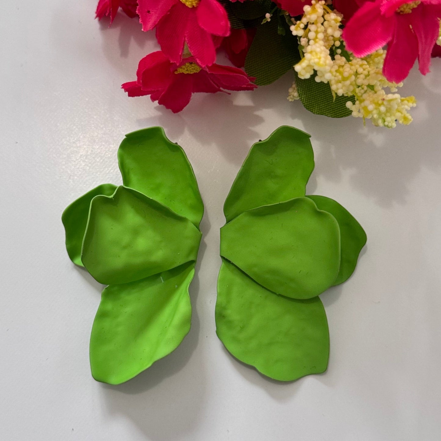 Make a lush style statement with these vibrant green leaf earrings, designed for trendsetters who love nature-inspired fashion. These earrings feature oversized, sculpted leaf silhouettes in a rich, fresh green hue, bringing a touch of tropical elegance to any outfit. 