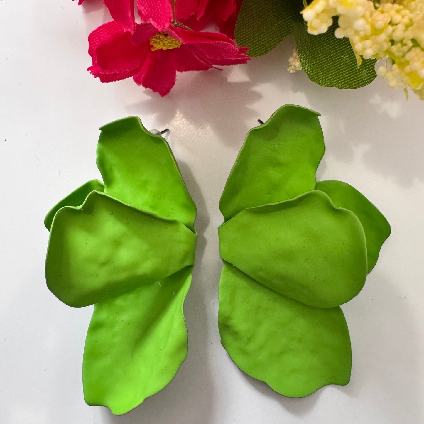 Make a lush style statement with these vibrant green leaf earrings, designed for trendsetters who love nature-inspired fashion. These earrings feature oversized, sculpted leaf silhouettes in a rich, fresh green hue, bringing a touch of tropical elegance to any outfit. 