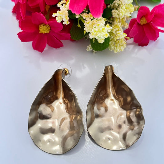 Introducing our Bold Gold Hammered Statement Earrings – a must-have for fashion-forward individuals who love to turn heads! These stunning teardrop-shaped earrings feature an organic, hand-hammered texture that shimmers beautifully with every movement, making them the perfect blend of elegance and boldness. C