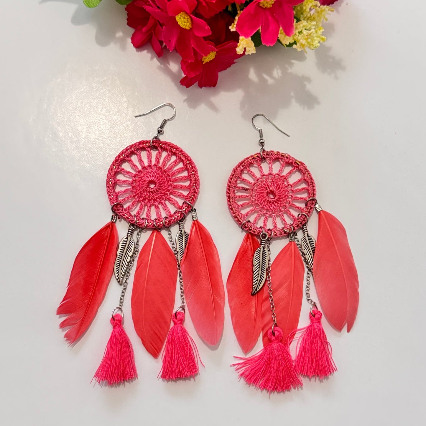 These intricately woven dreamcatcher-inspired earrings feature a stunning circular lace design, adorned with delicate feathers, silky tassels, and metallic leaf charms that sway beautifully with every movement.