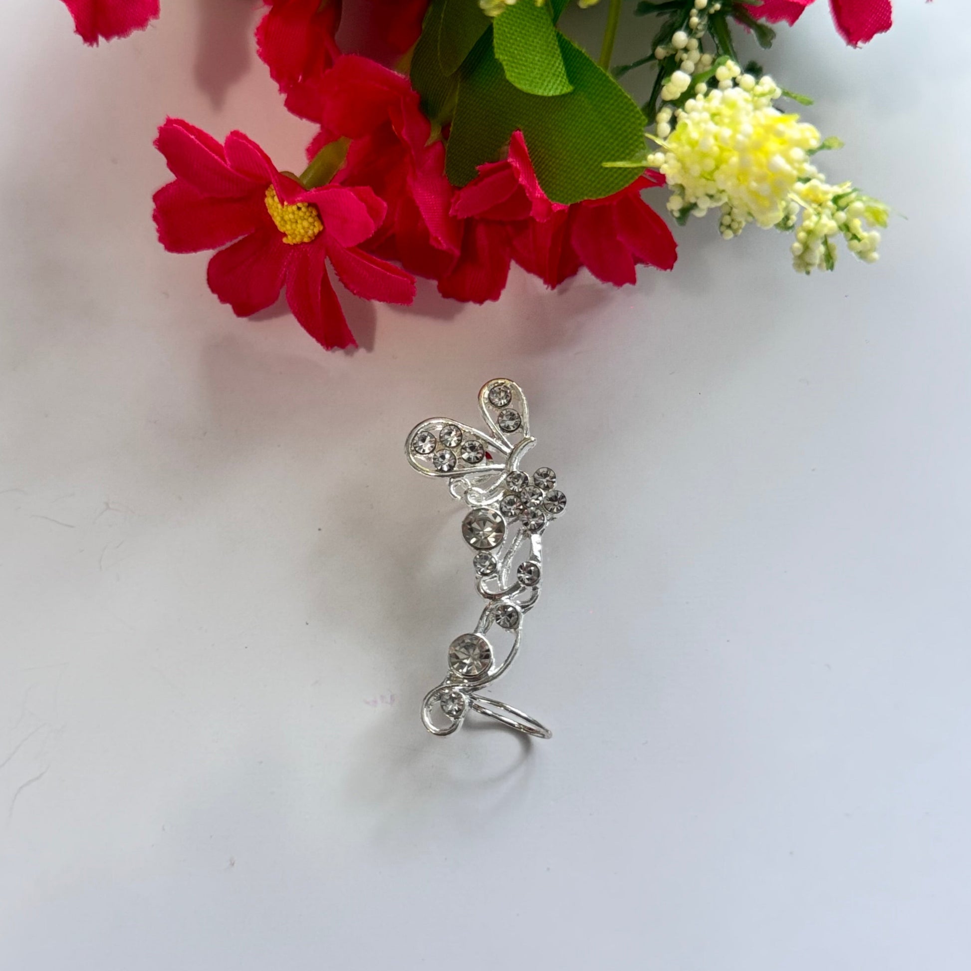Elevate your earring collection with this exquisite, gold-tone crystal butterfly ear cuff, a true embodiment of elegance and sophistication.