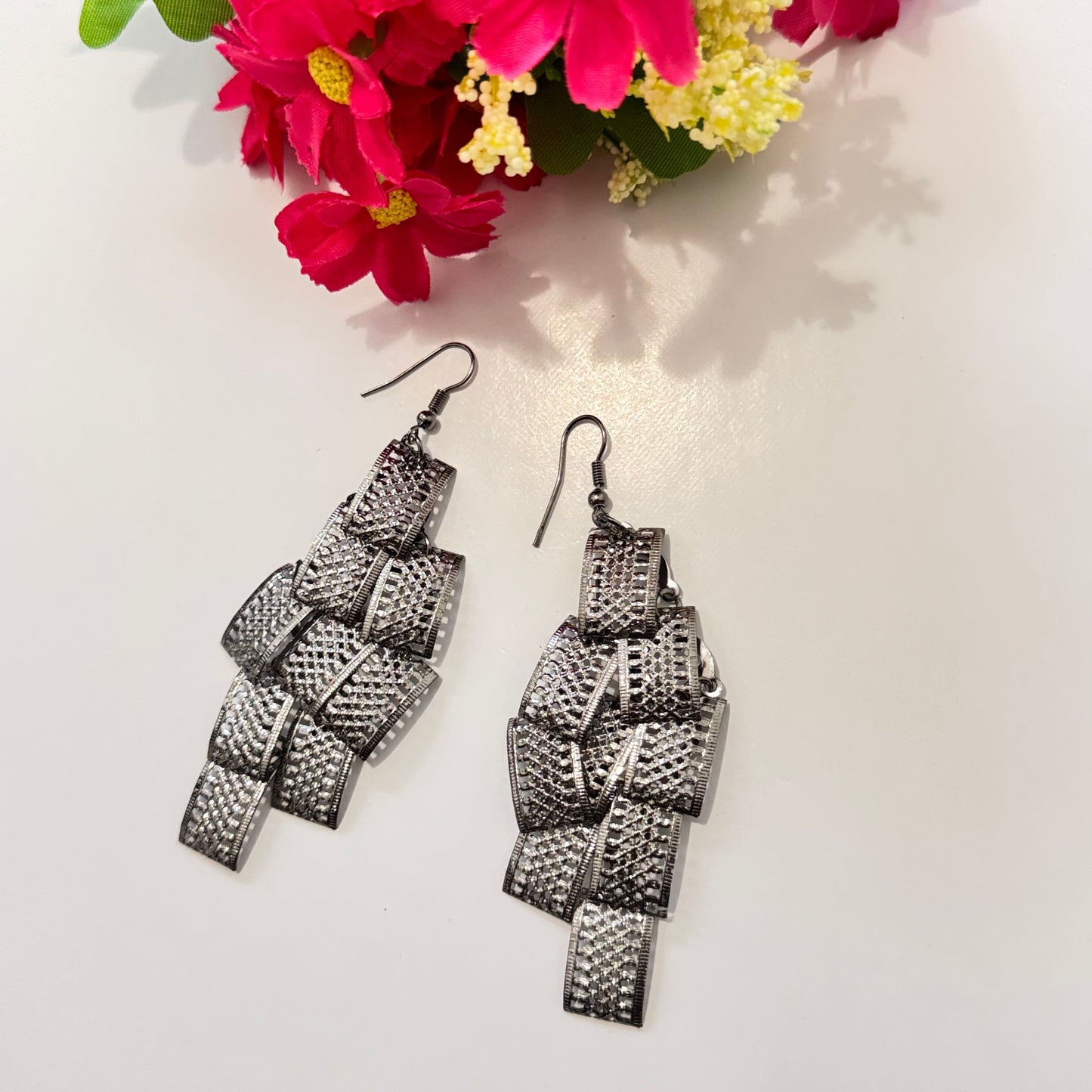 Unleash your bold and elegant side with these statement metal cascade earrings—a perfect blend of modern sophistication and timeless charm. Crafted with intricate, textured metal loops, these lightweight yet striking earrings exude a mesmerizing shimmer with every movement, making them the ultimate head-turner. 
