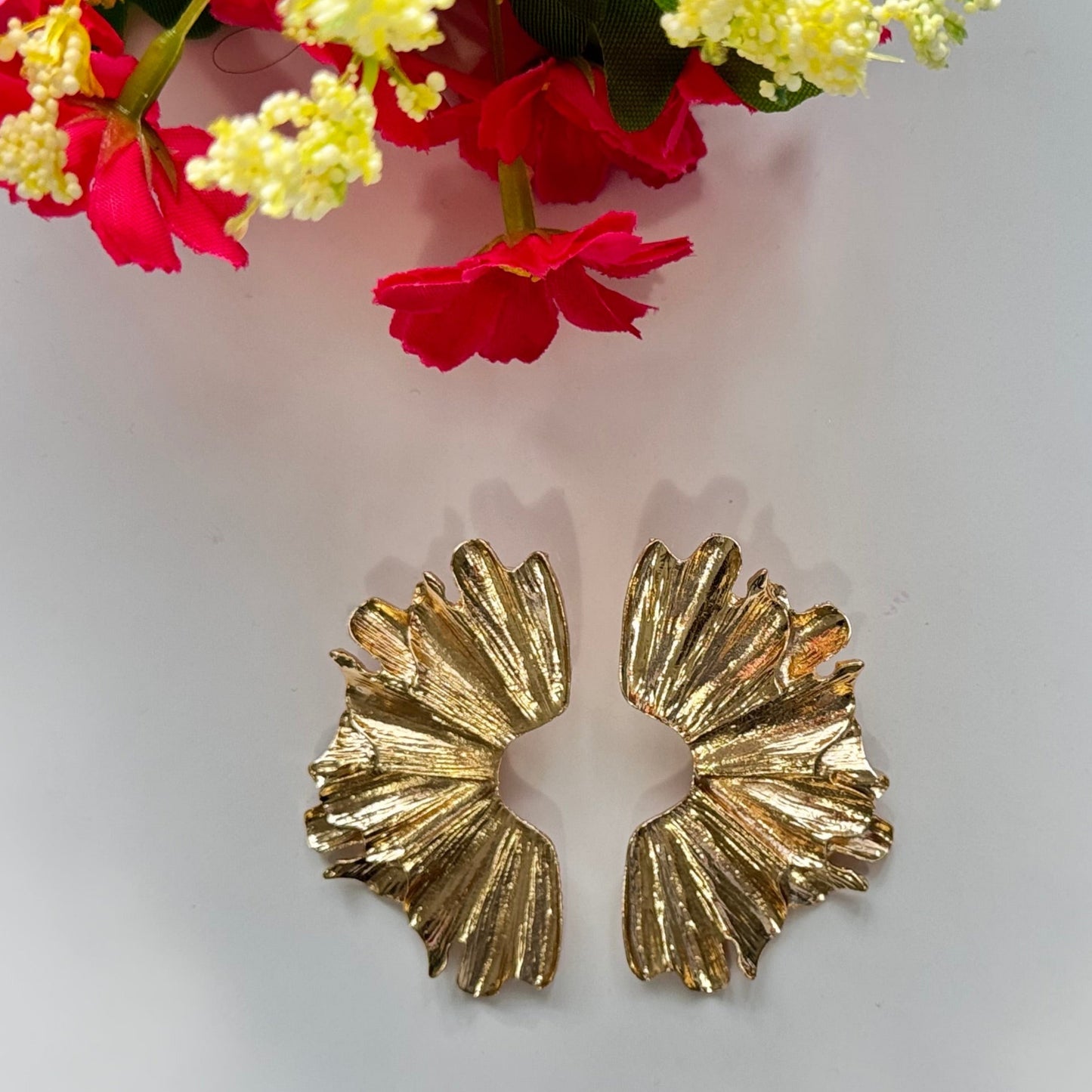 A true statement of elegance and bold sophistication. Crafted with a luxurious sculpted design, these earrings mimic the organic beauty of delicate wings, available in both radiant gold and striking silver finishes. Unique, asymmetric form and high-polish texture create a mesmerizing play of light, making them the perfect accessory to elevate any outfit. 