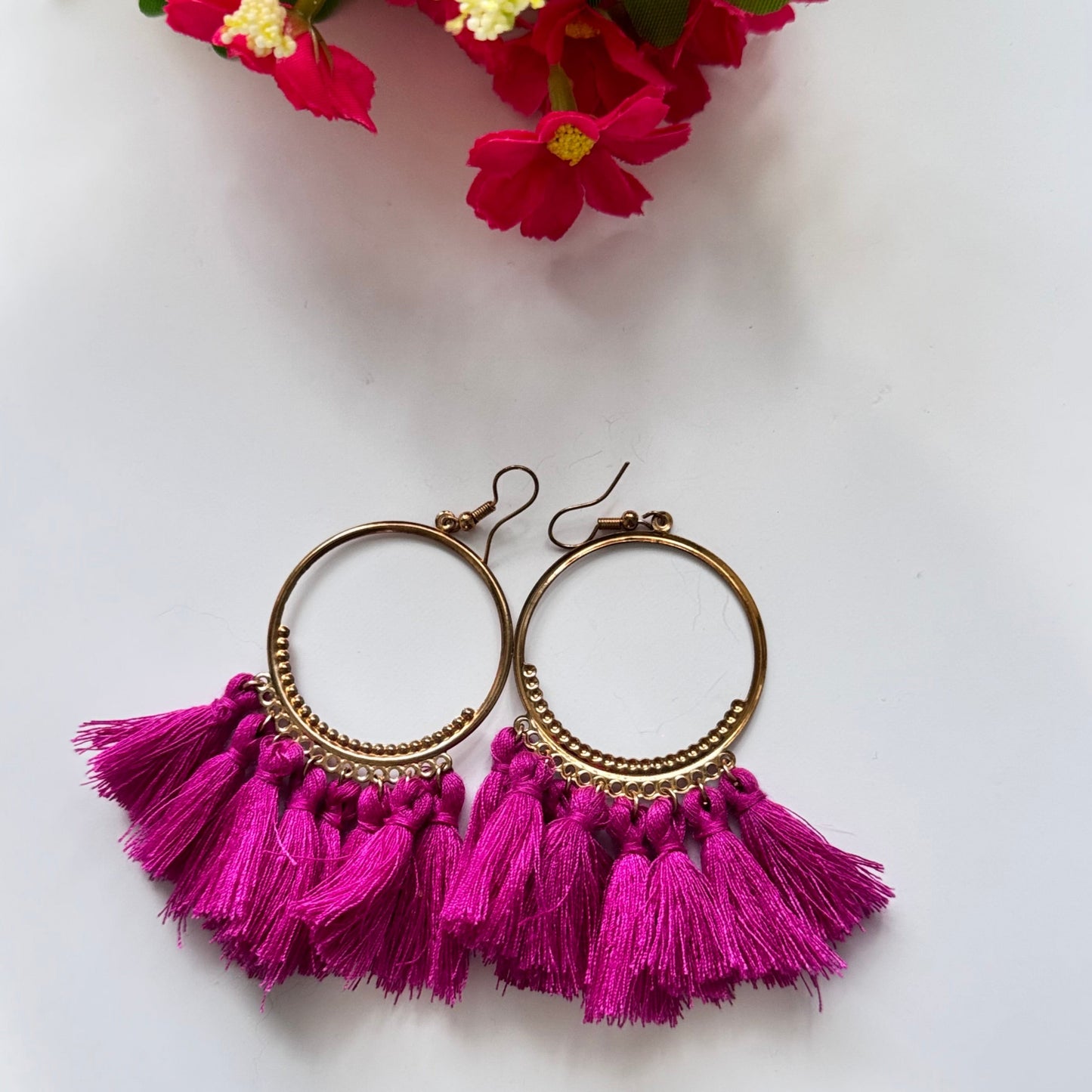 The perfect blend of elegance and bold style! Crafted with gold-tone hoops, these statement earrings feature vibrant, silky tassels in eye-catching shades of blue and magenta, designed to add a pop of color to any outfit