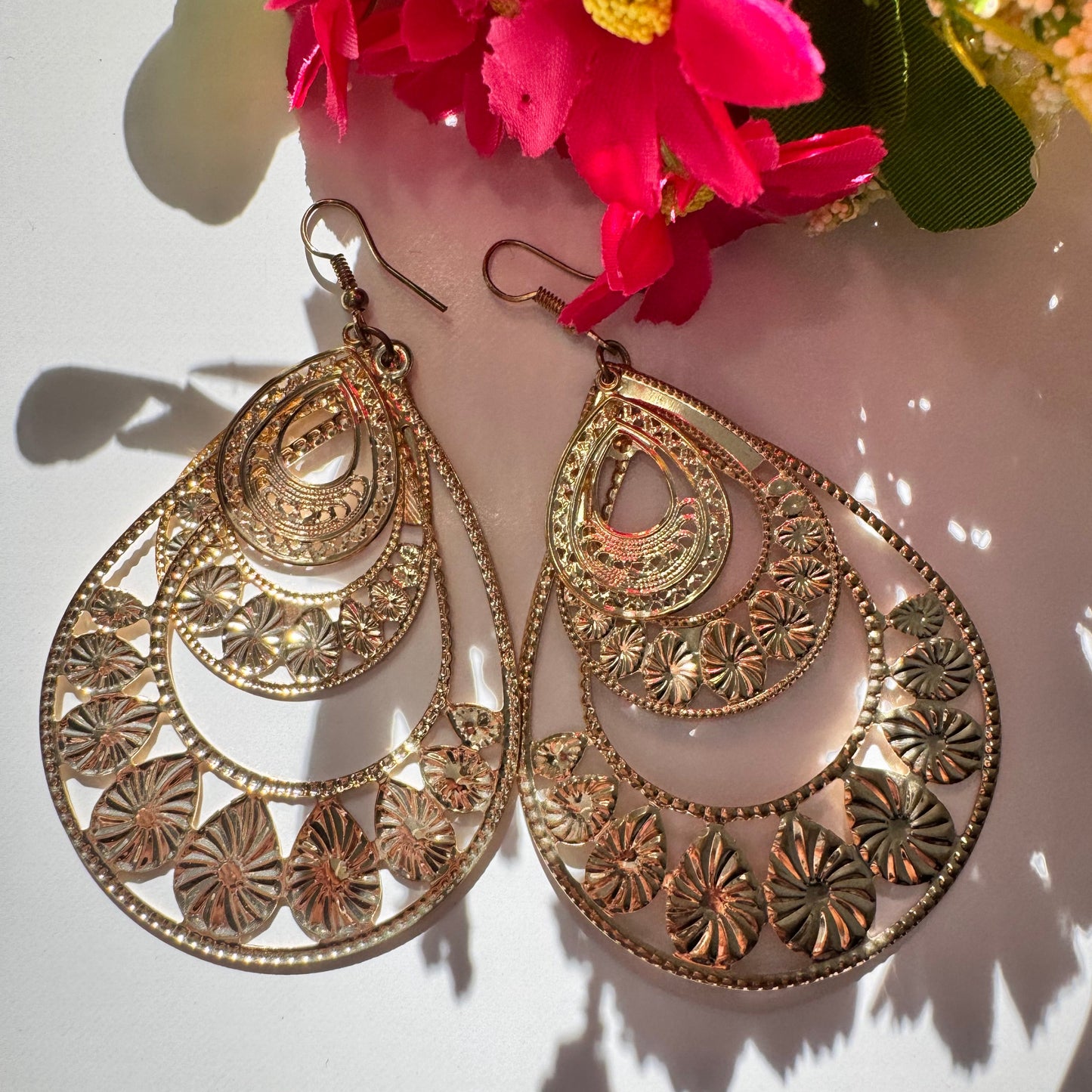 Elevate your style with our Intricate Filigree Teardrop Earrings, a breathtaking fusion of elegance and bohemian charm. Designed with delicate floral-inspired cutouts and cascading layered arches, these statement earrings capture the essence of timeless beauty and modern sophistication.