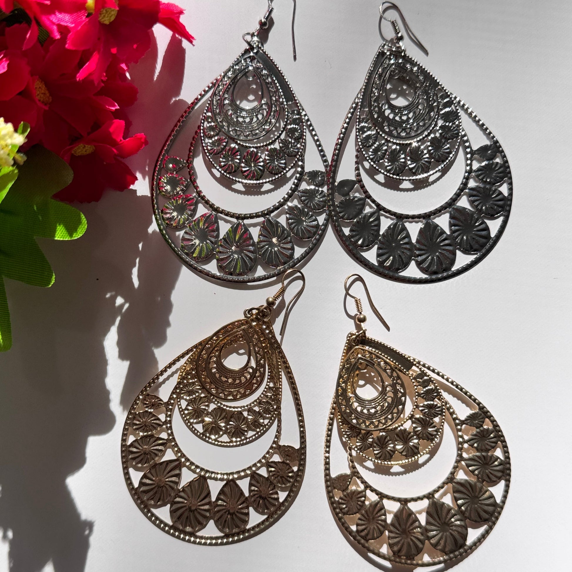 Elevate your style with our Intricate Filigree Teardrop Earrings, a breathtaking fusion of elegance and bohemian charm. Designed with delicate floral-inspired cutouts and cascading layered arches, these statement earrings capture the essence of timeless beauty and modern sophistication.