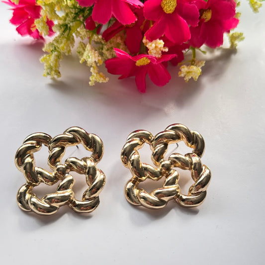 Make a bold and sophisticated statement with these exquisite gold-tone knot earrings, designed to add a touch of timeless elegance to any outfit. Featuring an intricate twisted rope design in a chic floral-inspired shape, these earrings radiate luxury and refinement.