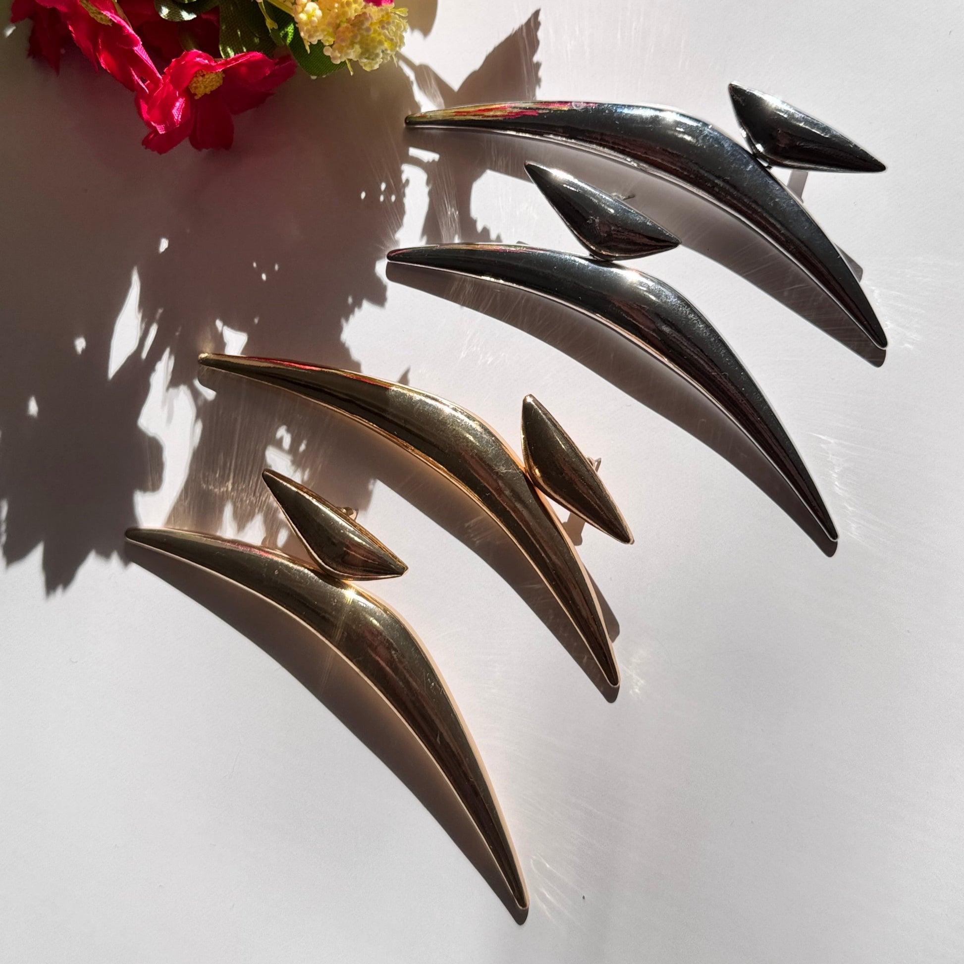 Elevate your style with these semi-crescent statement earrings, a perfect blend of modern elegance and celestial allure. Crafted in radiant gold and sleek silver finishes, these sculptural earrings feature a bold, curved design inspired by the fluidity of motion and the mystique of the crescent moon. 