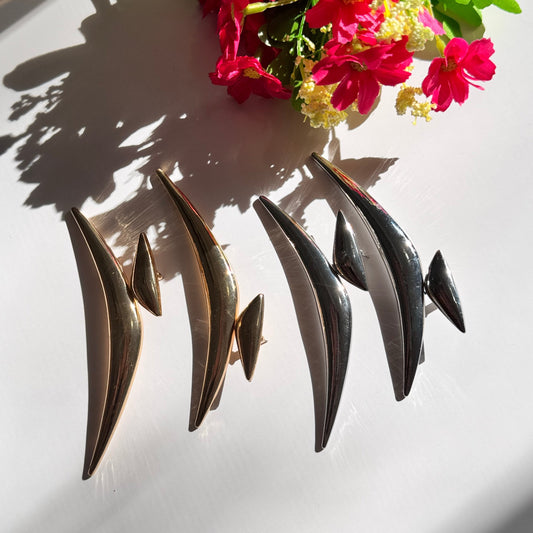 Elevate your style with these semi-crescent statement earrings, a perfect blend of modern elegance and celestial allure. Crafted in radiant gold and sleek silver finishes, these sculptural earrings feature a bold, curved design inspired by the fluidity of motion and the mystique of the crescent moon. 