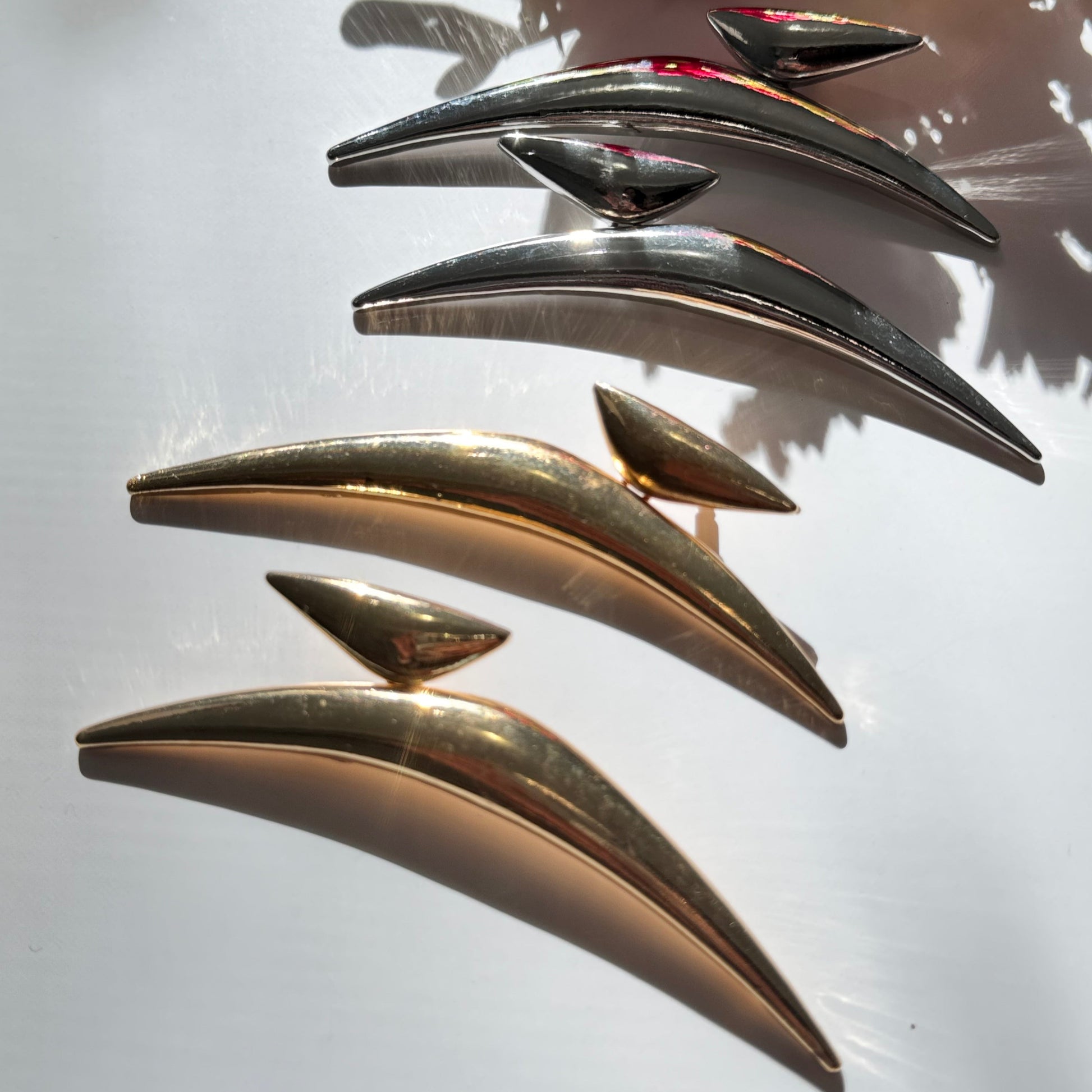 Elevate your style with these semi-crescent statement earrings, a perfect blend of modern elegance and celestial allure. Crafted in radiant gold and sleek silver finishes, these sculptural earrings feature a bold, curved design inspired by the fluidity of motion and the mystique of the crescent moon. 