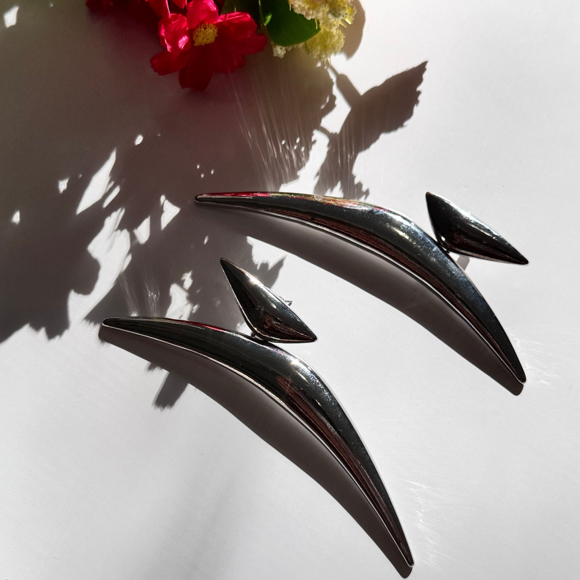 Elevate your style with these semi-crescent statement earrings, a perfect blend of modern elegance and celestial allure. Crafted in radiant gold and sleek silver finishes, these sculptural earrings feature a bold, curved design inspired by the fluidity of motion and the mystique of the crescent moon. 