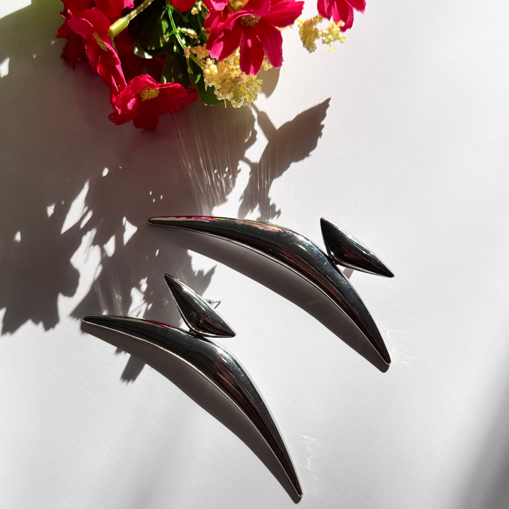 Elevate your style with these semi-crescent statement earrings, a perfect blend of modern elegance and celestial allure. Crafted in radiant gold and sleek silver finishes, these sculptural earrings feature a bold, curved design inspired by the fluidity of motion and the mystique of the crescent moon. 