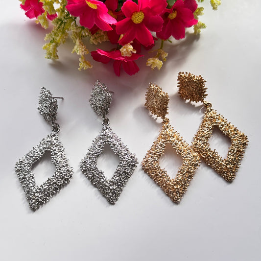 Elevate your style with these dazzling geometric statement earrings, designed to add a touch of elegance and modern sophistication to any outfit. Crafted with a unique textured finish, these bold earrings come in both radiant gold and shimmering silver.