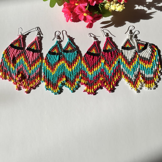 Elevate your style with these&nbsp;beaded earrings, a perfect blend of vibrant colors and intricate craftsmanship. Designed for bold, confident individuals, these statement earrings are inspired by traditional beadwork, featuring a chevron zigzag pattern that adds a unique artistic touch.